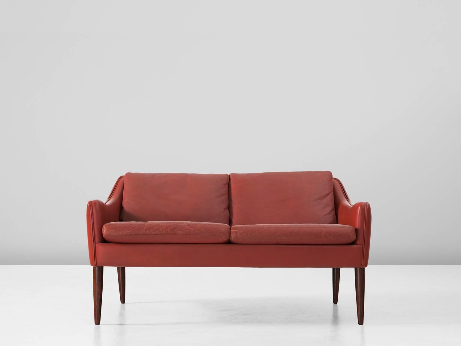 Living room set in rosewood and leather by Hans Olsen for CS Møbler, Denmark before 1963.

Red leather settee by Danish designer Hans Olsen. This sofa shows interesting lines, which create an open look. The four high cylindrical legs are tapered.