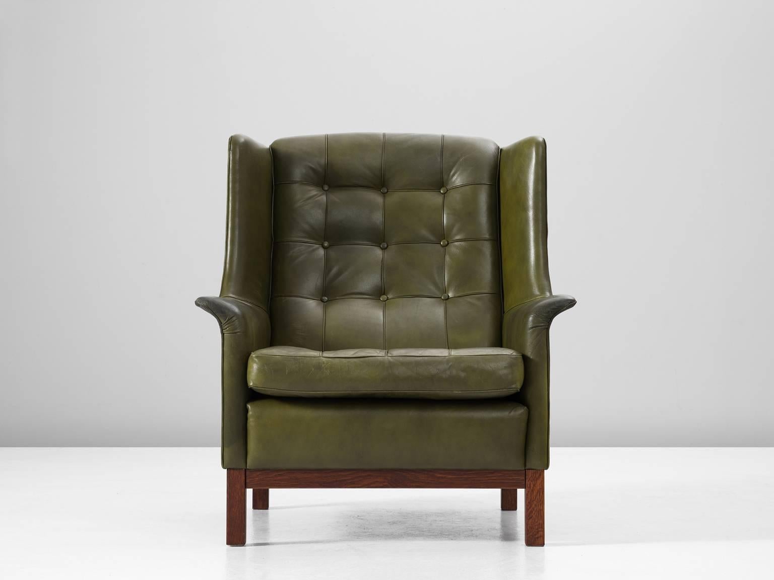 High back chair, in leather and wood by Arne Norell, Sweden, 1960s.

Wonderful comfortable green buffalo leather easy chair by Swedish designer Arne Norell. This lounge chair comes with a very high standard of comfort, as where Norell is known for.