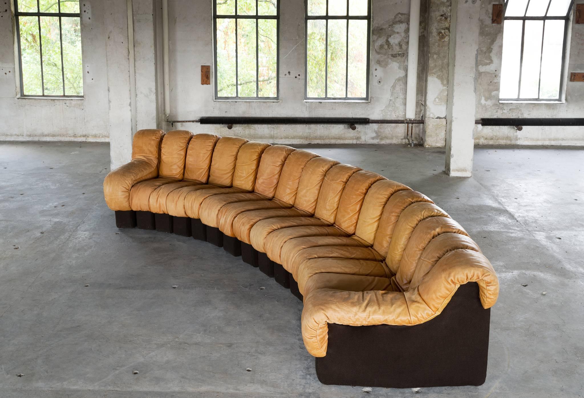 De Sede ‘Snake’ DS-600 sectional sofa, in leather, Switzerland, 1972. 

De Sede 'Non Stop' sectional sofa, containing 16 pieces in original cognac leather, of which 14 center pieces and two armrests. A well known design by Swiss manufacturer De
