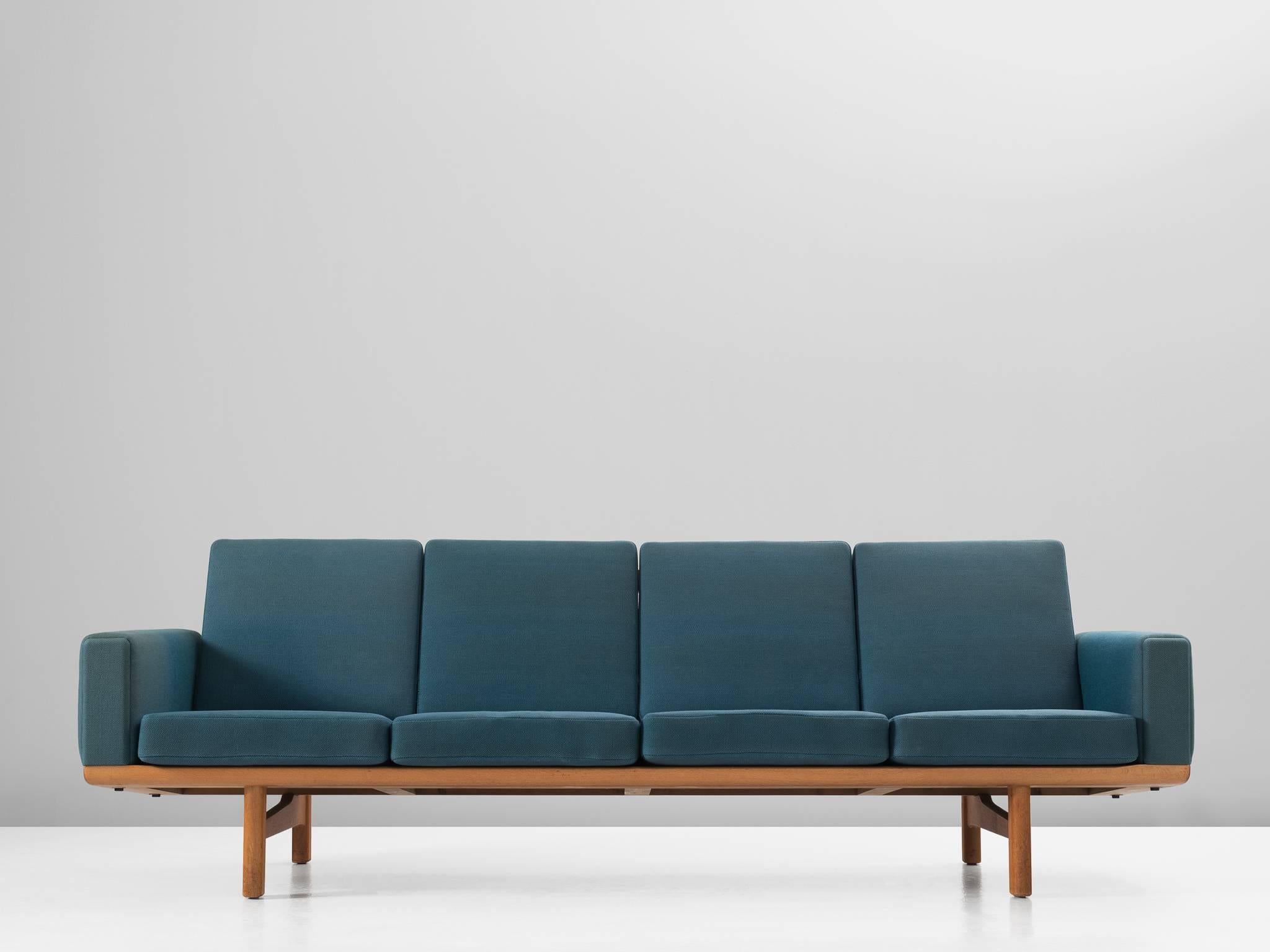 Sofa GE236/4, in oak and fabric, by Hans Wegner for GETAMA, Denmark, 1950s. 

Sofa designed by Hans Wegner for GETAMA. This sofa has a solid oak frame with real nice construction details. Due to the high legs and the low but detailed back, this sofa