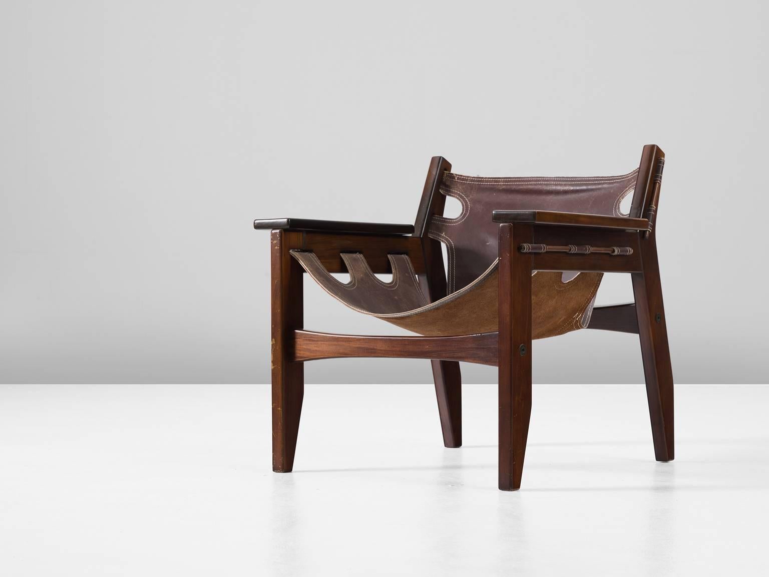 'Kilin' armchair, in rosewood and leather by Sergio Rodrigues for OCA, Brazil, 1973. 

'Kilin' easy chair in Jacaranda rosewood and brown leather. This chair has a sturdy appearance and is designed with high attention to detail. The thick saddle
