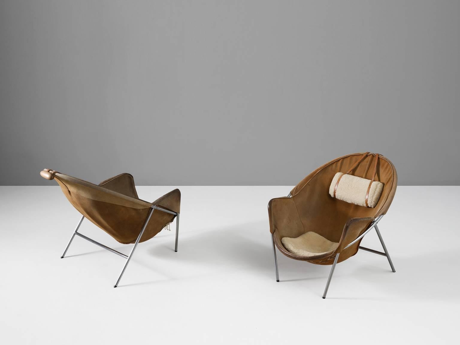 Lounge chair, in metal, suede, fabric and wood, by Erik Ole Jorgensen for Olaf Black, Denmark, 1953. 

Exceptional set of two easy chairs in cognac suede. These sling chairs consist of a chromed tubular frame in which the suede seating hangs.