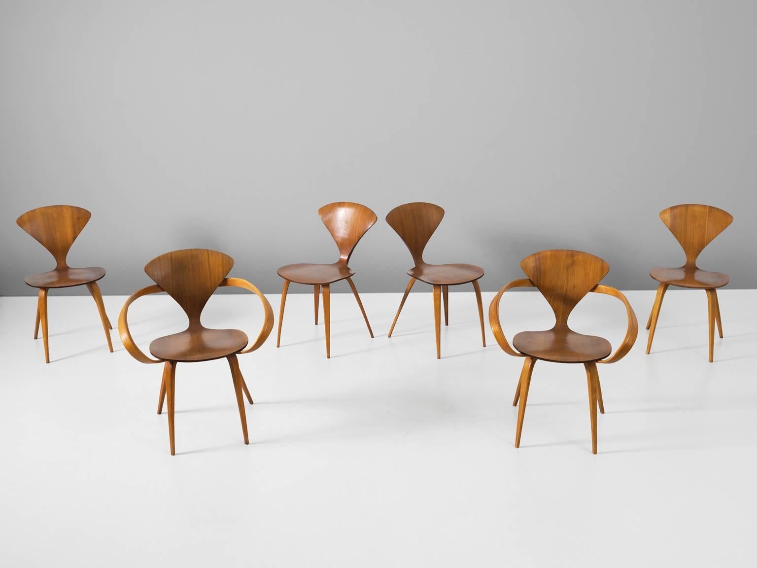 Set of six dining chairs, in walnut and plywood, by Norman Cherner for Plycraft, United States 1957. 

On offer are two Classic Norman Cherner plywood chairs with and four without armrests from 1957. The perfect combination. Their iconic shape