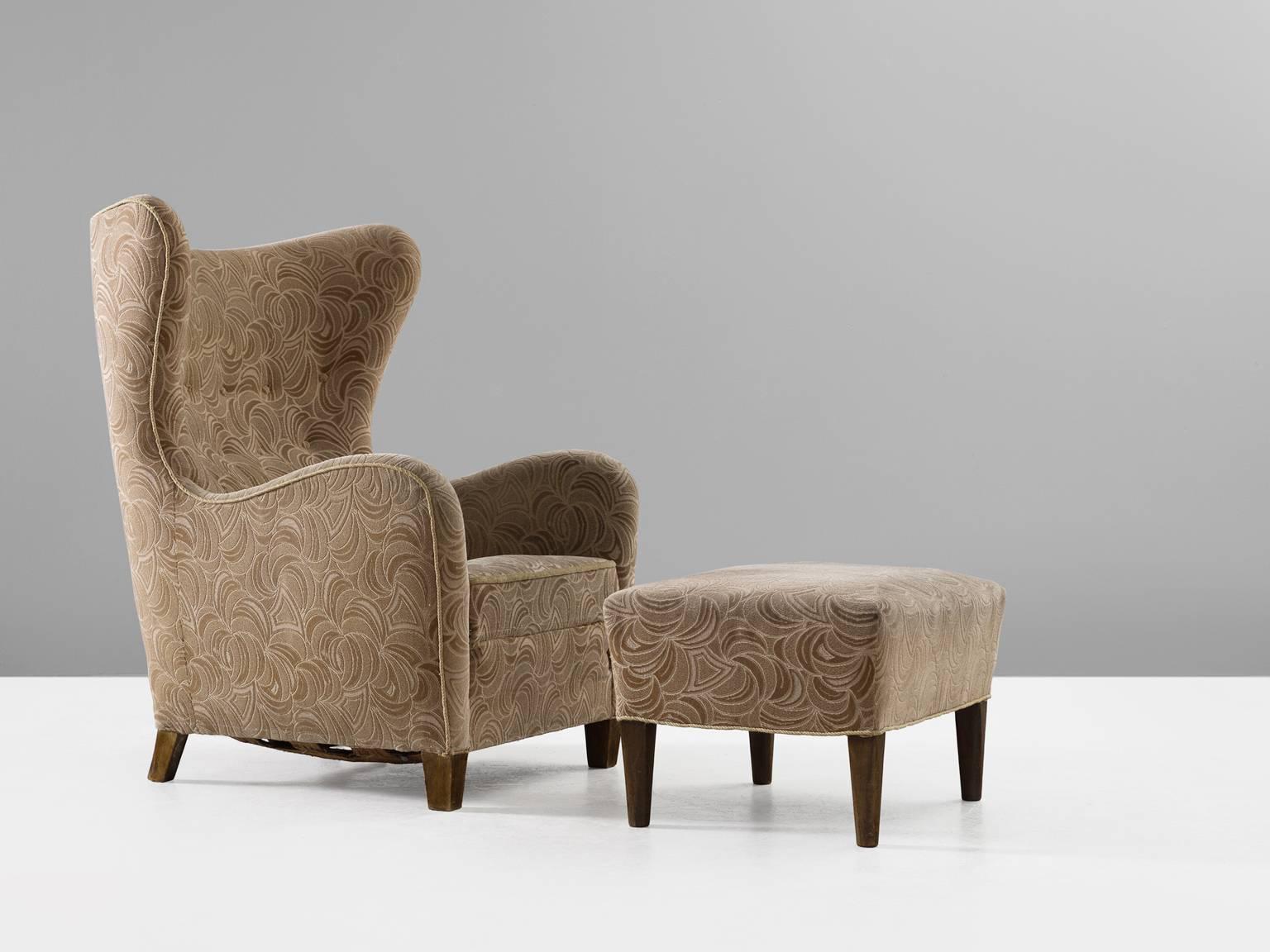 Wingback chair, in oak and fabric, for Thorald Matsen jr. for Thorald Madsen Snedkeri, Denmark, 1942. 

Classical high back chair, with beautiful tufted back. The chair is combined with a matching ottoman which makes this a rare find. The design for