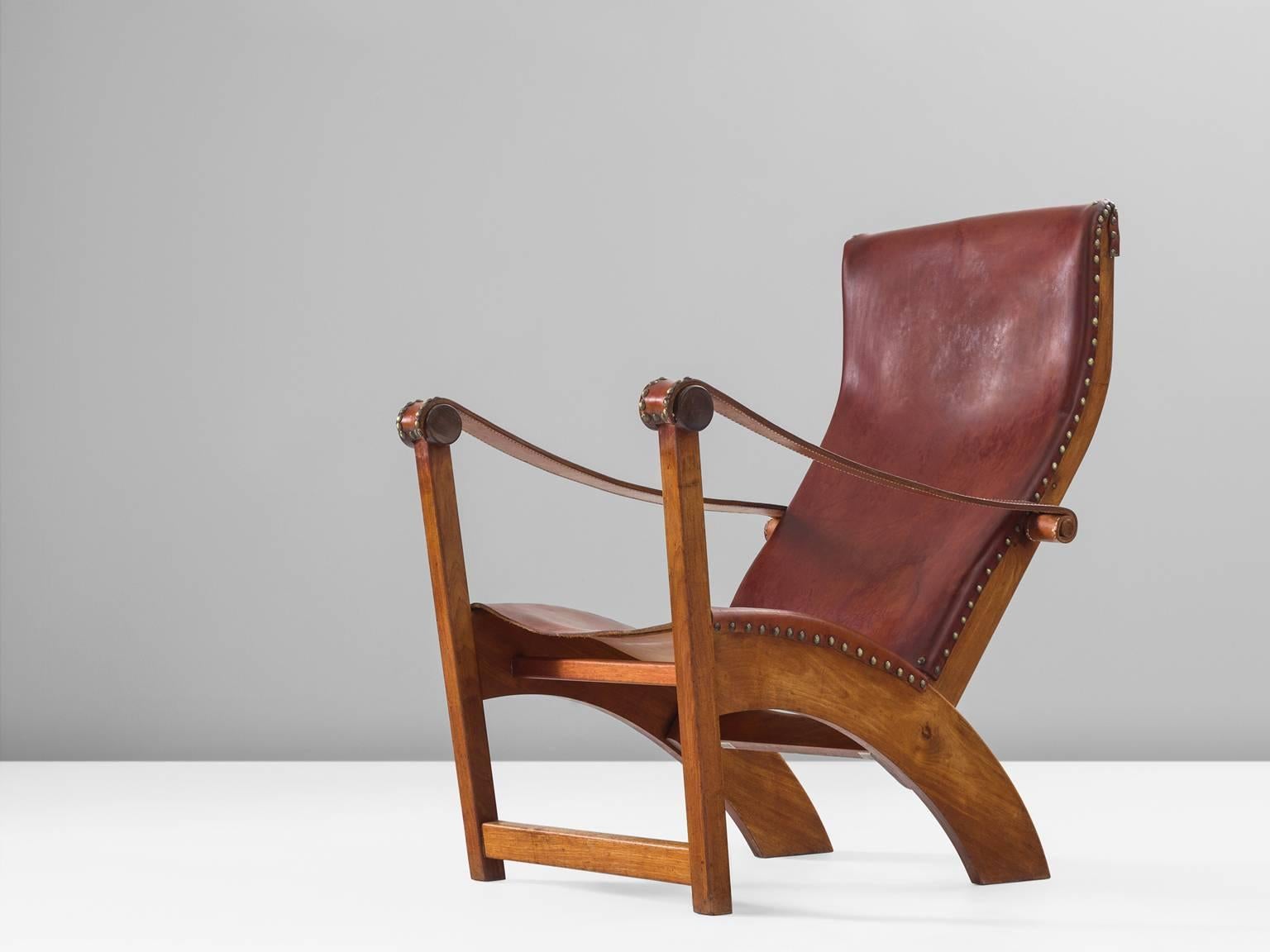 Lounge chair model 'Københavnerstolen', in mahogany and leather, by Mogens Voltelen for Niels Vodder, Denmark, 1936. 

This is the so called Copenhagen chair by Mogens Voltelen. This chair shows beautiful lines as seen on the arched legs on the back