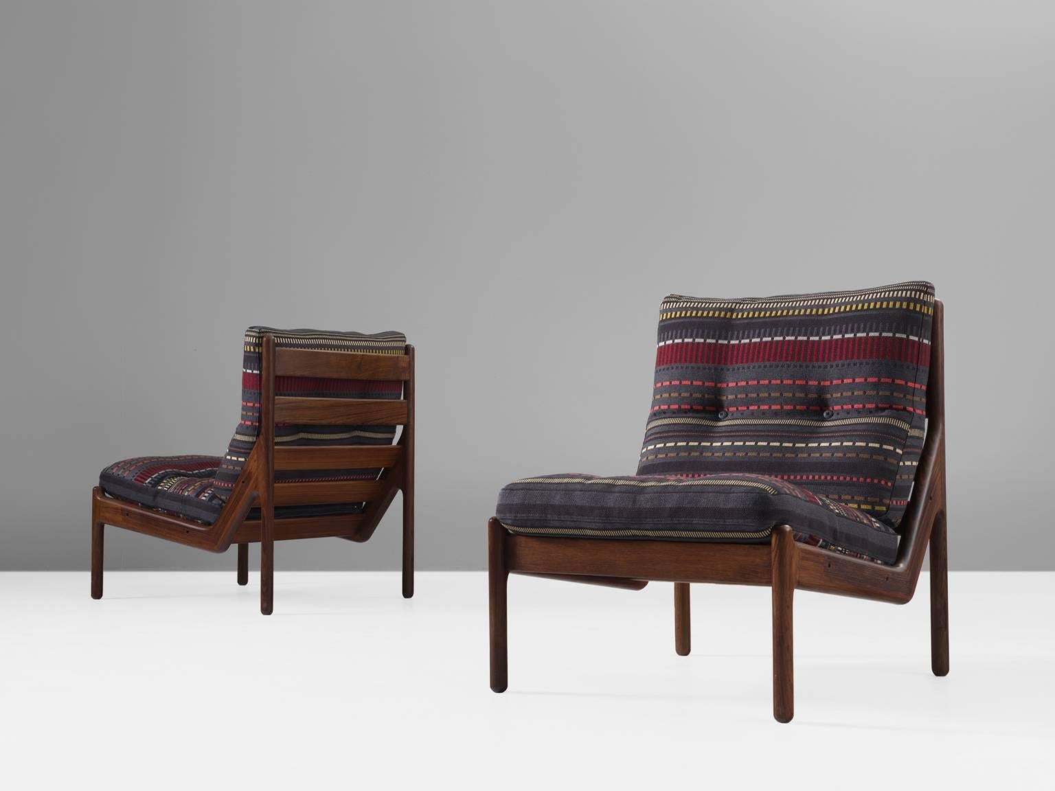 Pair of easy chairs, in oak and leather, by Illum Wikkelsø for C.F. Christensen, Denmark, 1972. 

Set of two armchairs, reupholstered in Point 007 Maharam by Kvadrat, designed by Paul Smith. Please note that the with the cushion show a frame in