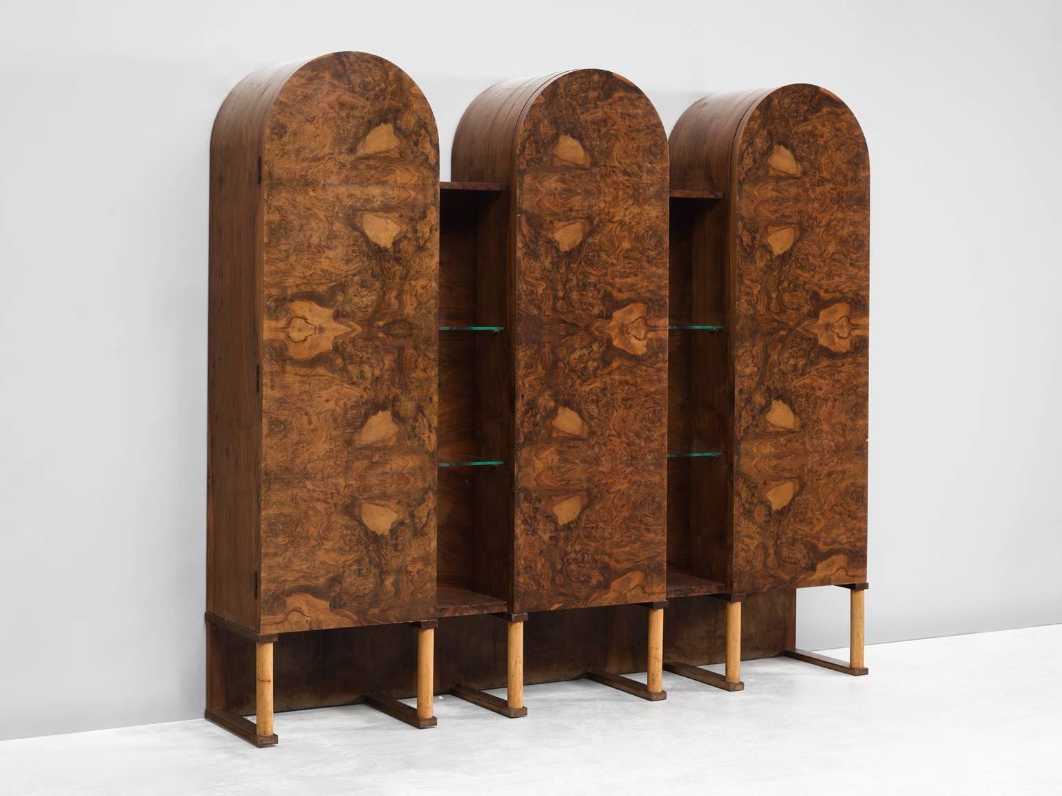 Cabinet, walnut burl, wood, glass, Italy, 1960s.

This sensuous cabinet is executed in walnut burl. The cabinet features three arches with three burl doors, and four shelves. In between the arches are open gaps with featuring two glass shelves.