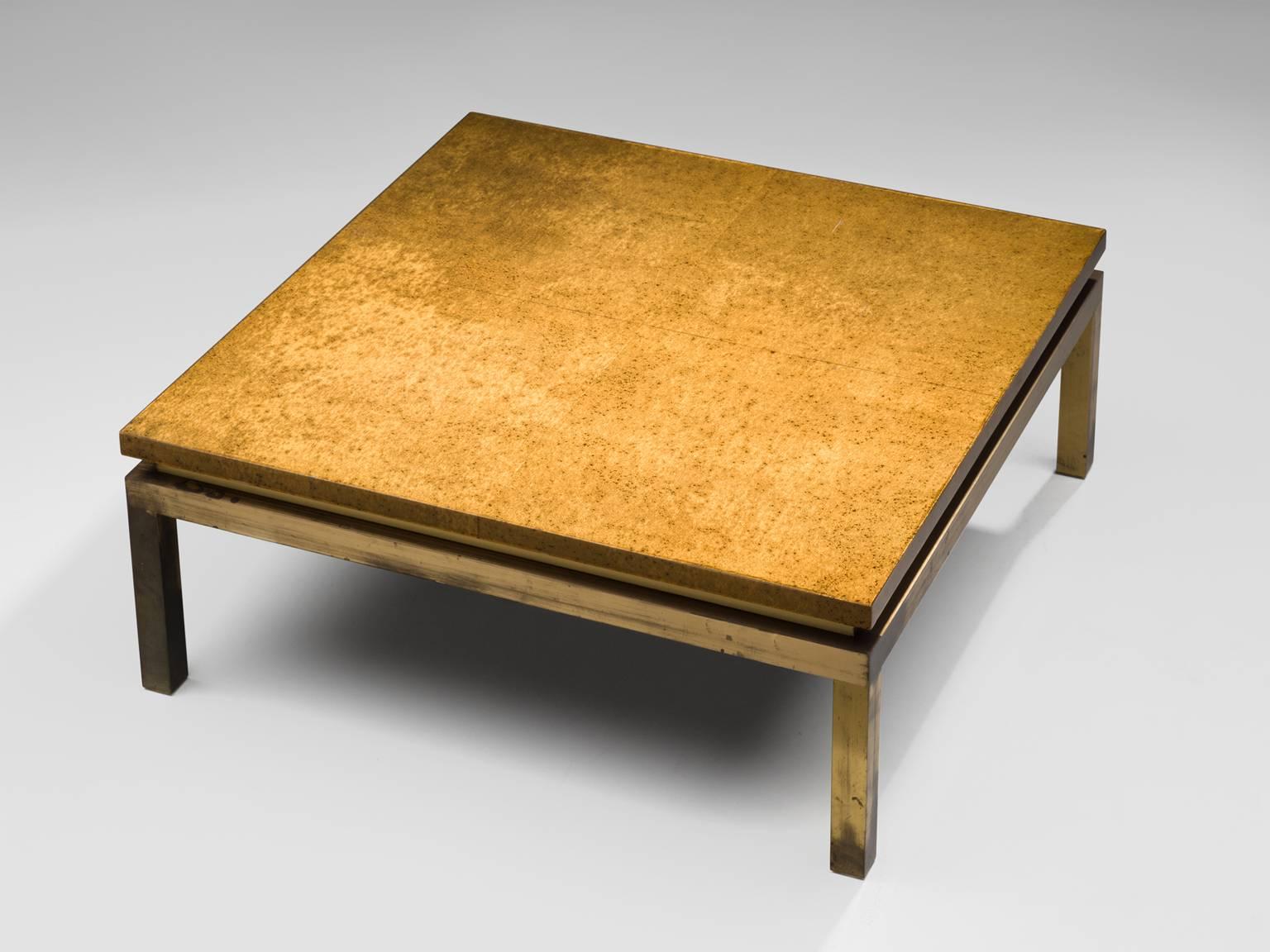 Coffee table, brass and lacquered wood, Europe, 1950s.

This sparkling solid coffee table with brass base is all about material. The design itself is fairly simple with a square top and base and four legs. There is a space between the top and the