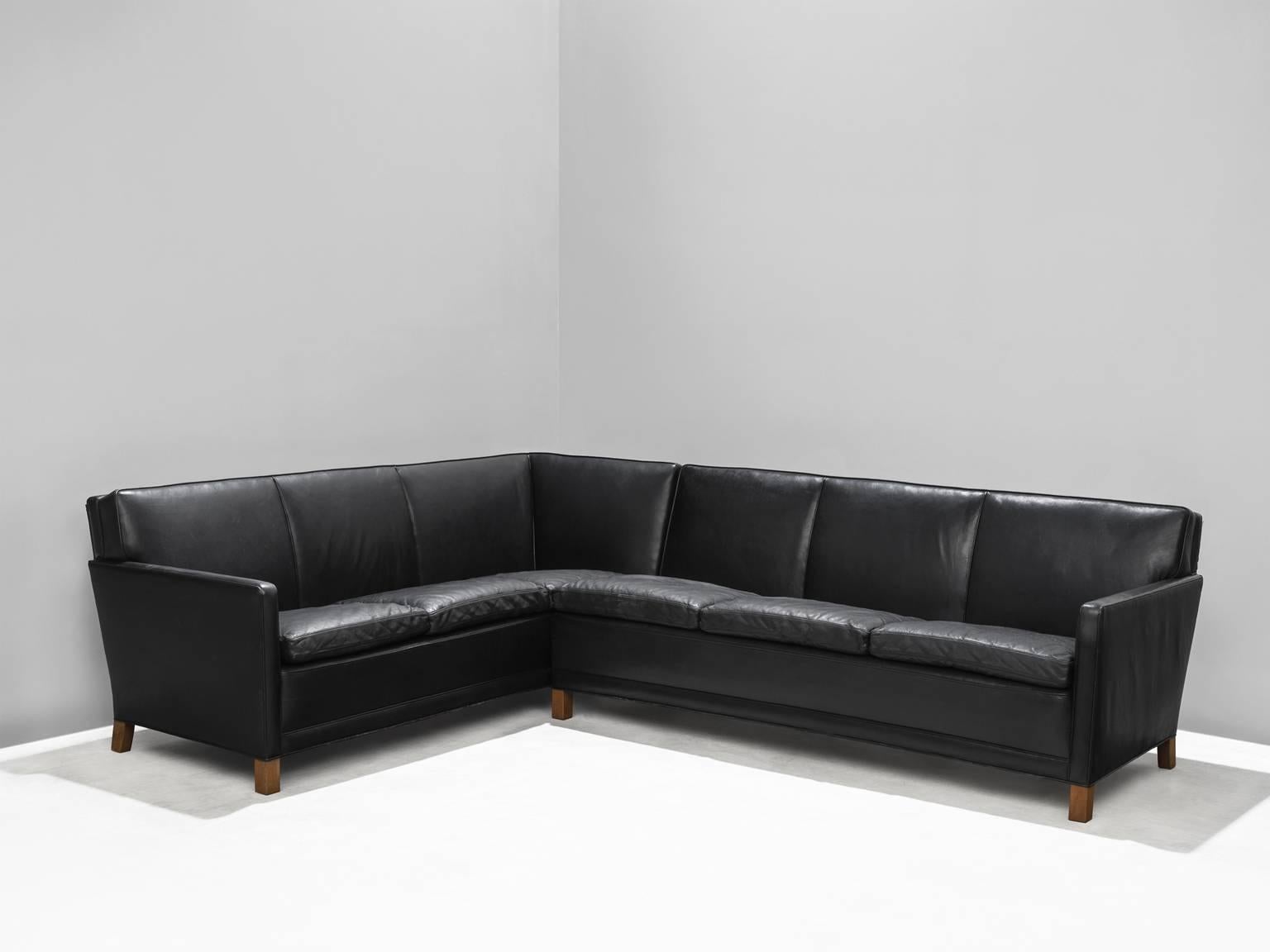 Corner sofa in black leather, foam and wood, Denmark, 1950s.

This sturdy and comfortable sofa is both functional and comfortable at the same time. This archetypical design of the fifties in Denmark has six sitting elements and will easily