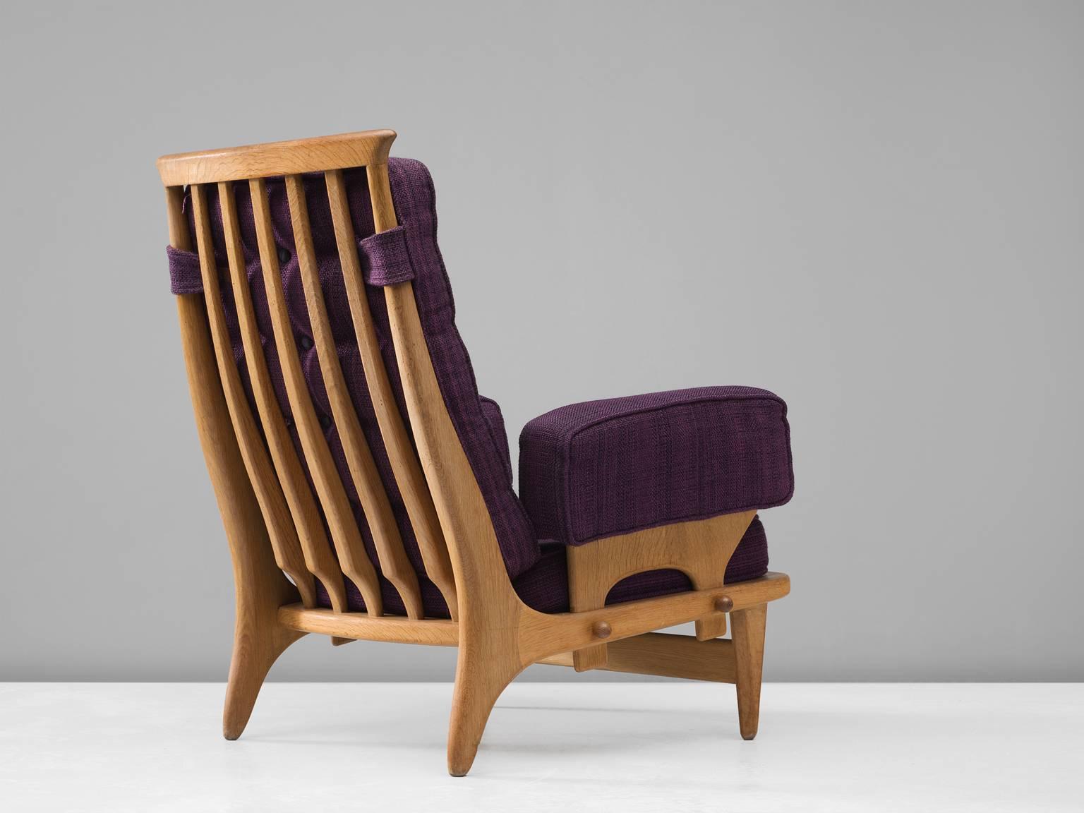 Guillerme & Chambron, easy chair in purple fabric and oak, 1940s, France.

This high back lounge chair in solid oak with the typical characteristic decorative details at the back and capricious forms of the legs. This distinctive chair in