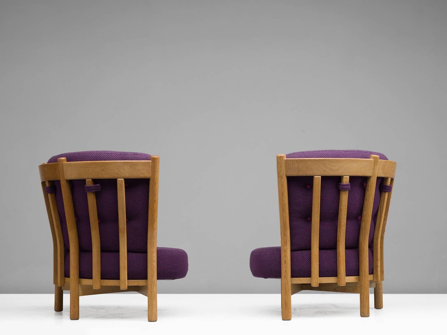 Guillerme & Chambron, easy chairs in purple fabric and oak, 1940s, France.

These distinctive chairs in beautifully patinated oak are by the French designer duo Jacques Chambron & Guillerme. These high back lounge chairs in solid oak share the