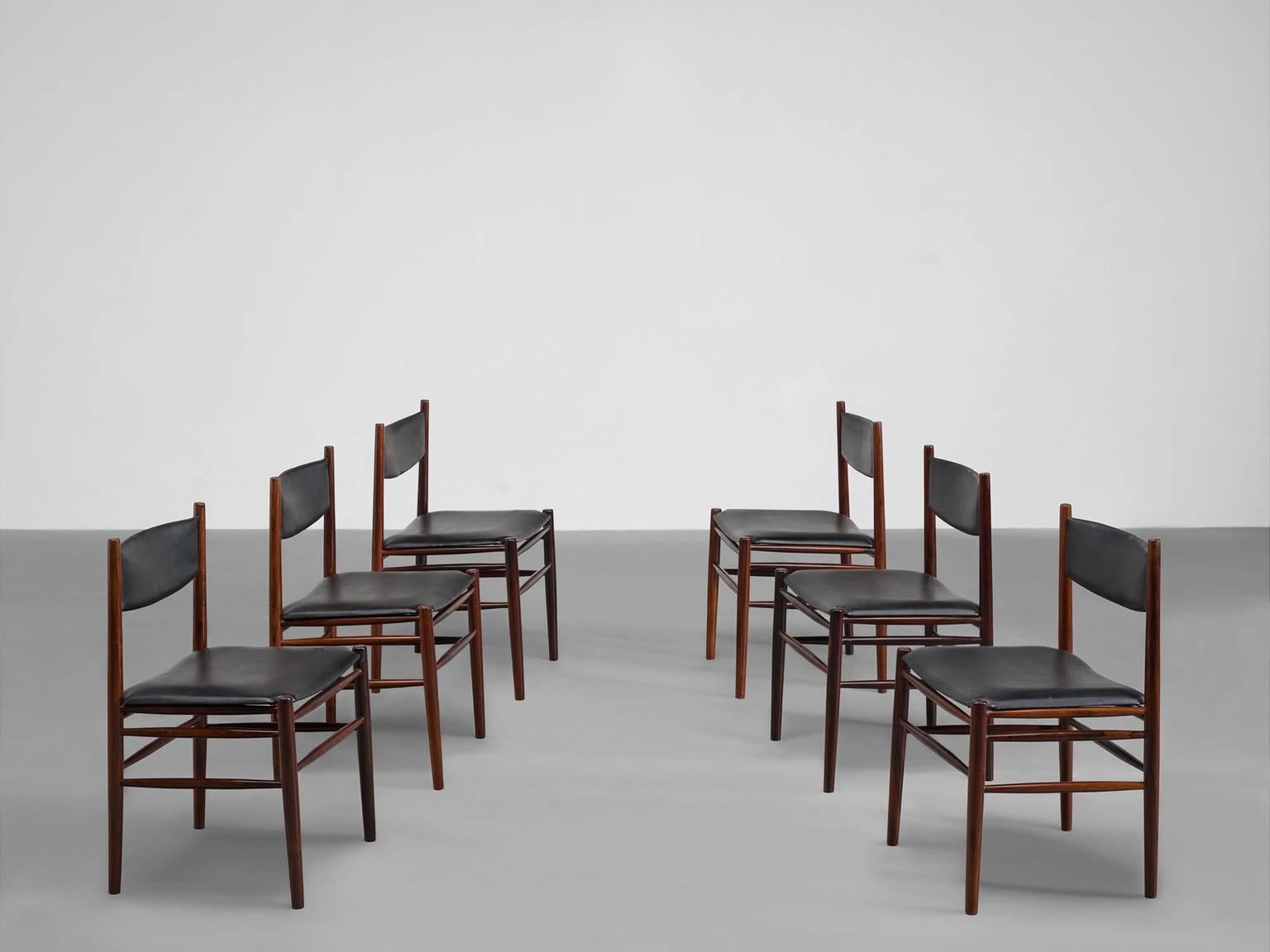 Dining chairs, rosewood, leather, Denmark, 1960s.

This set of six rosewood and leather chairs is elegant and formal. The straight legs are connected via two horizontal slats. The lining of these well-executed chairs is straight yet still show off a