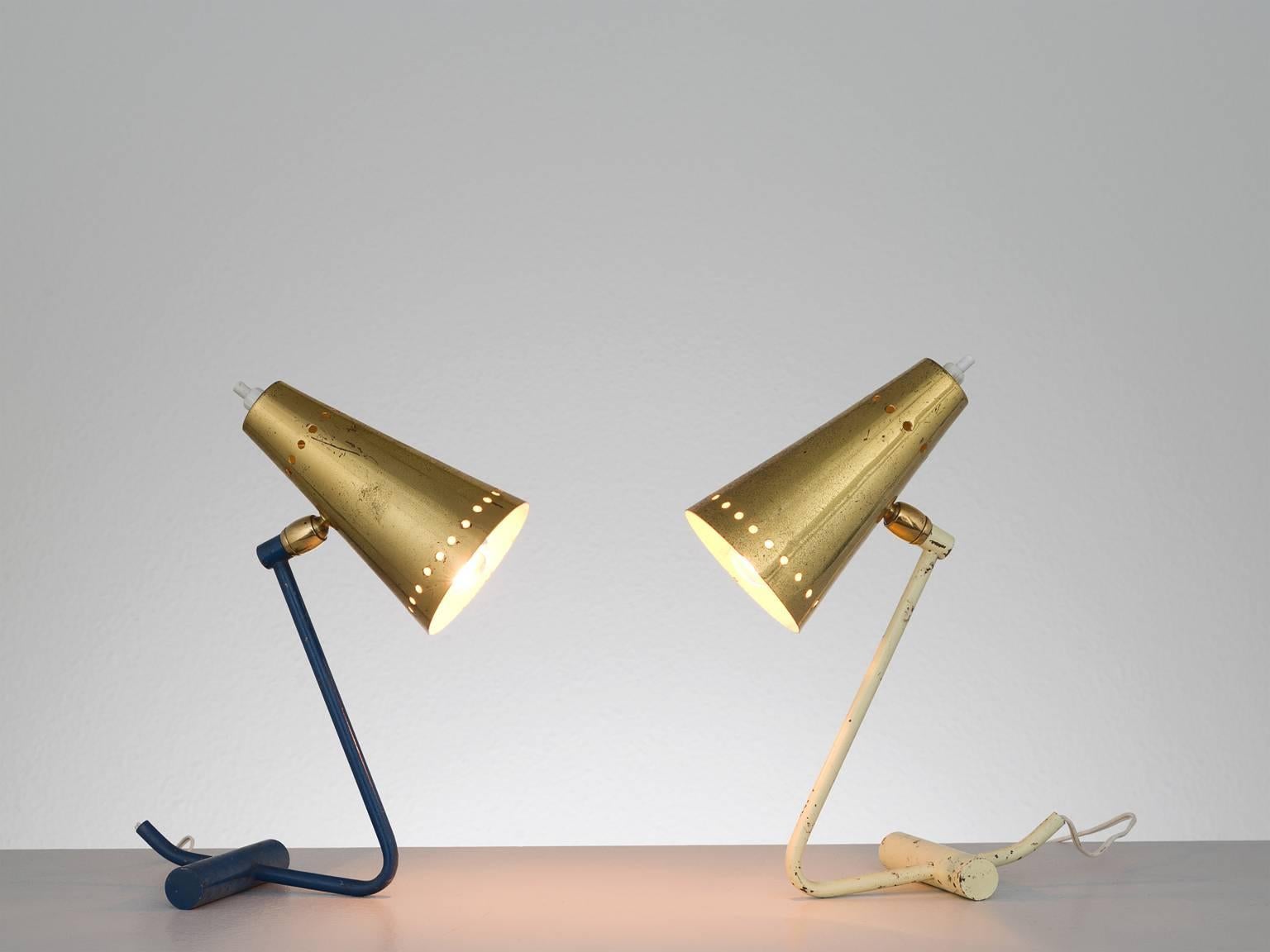 Table lamps, brass, metal, Italy, 1960s.

These two desk lamps feature are executed in brass and metal and feature two typical Stilnovo shades with the recognizable holes in on the rim of the shade that form a circle. The base of these small,