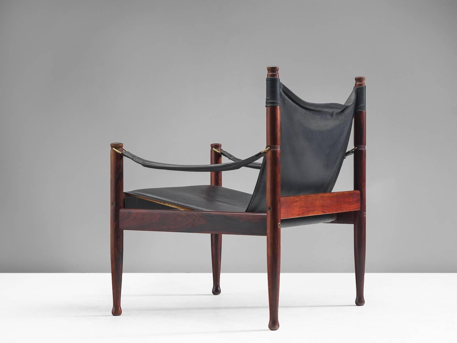 Erik Wørts safari lounge chairs in rosewood and black leather, Denmark, 1950s.

Sculptural lounge chairs in black leather. These chairs appear as a dynamic piece of furniture due to their flowing lines in the leather and straight rosewood frame. The