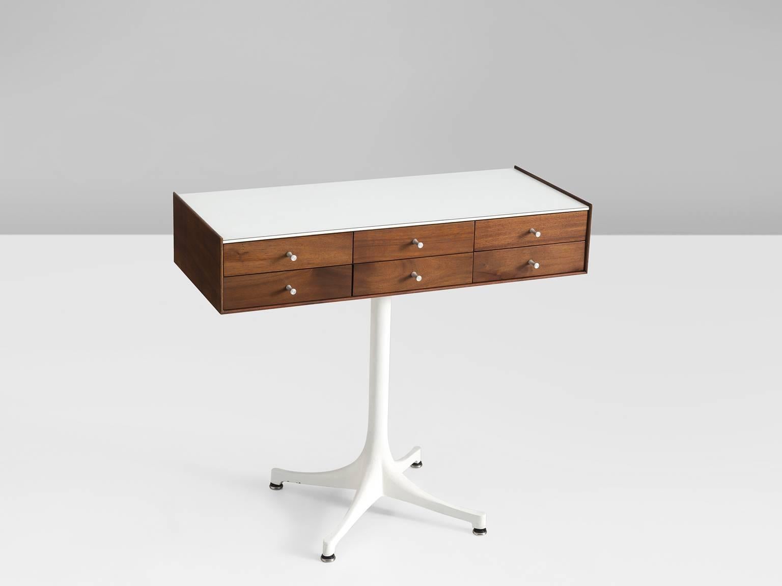 George Nelson for Herman Miller, miniature chest 5212, walnut, laminate and aluminum, United States, 1952.

This elegant small storage piece has a rectangular volume and is devided with six drawers with small white knobs on the front. The white