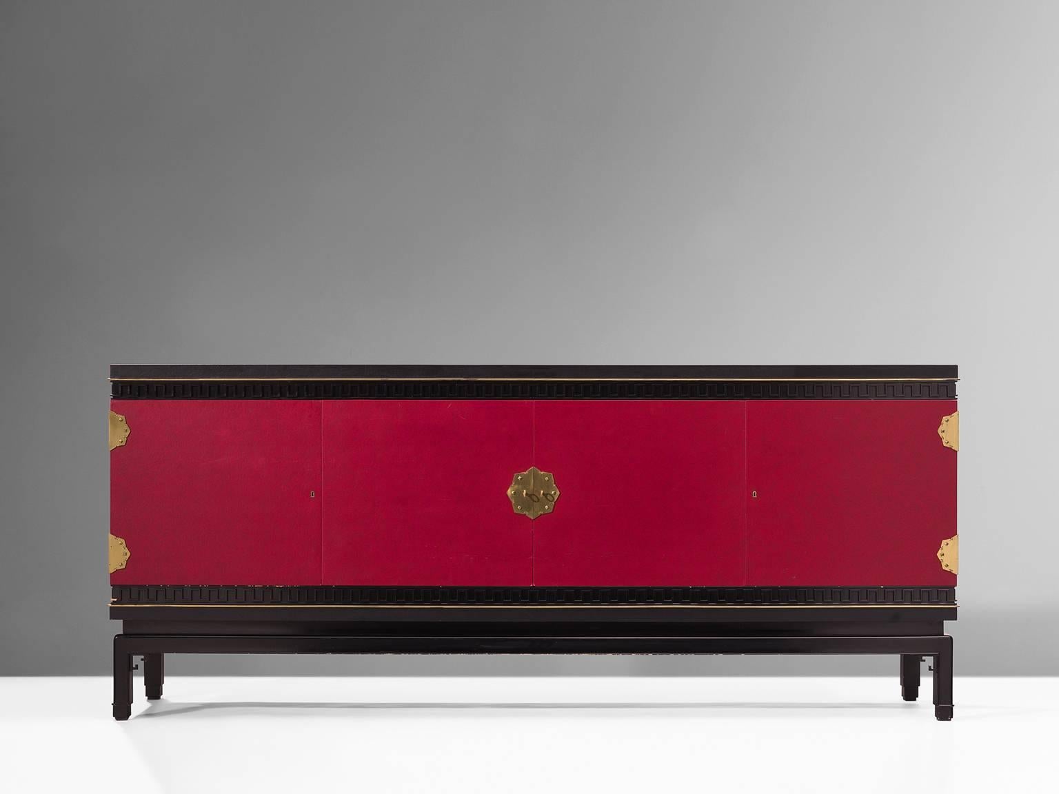 Sideboard, in oak, brass and skai, by De Coene, Belgium, 1960s. 

Rare early Art Deco style sideboard in oak and skai, signed by Belgian De Coene Frères. This credenza shows a beautiful deep red colour with brass details. The detailing has hints of