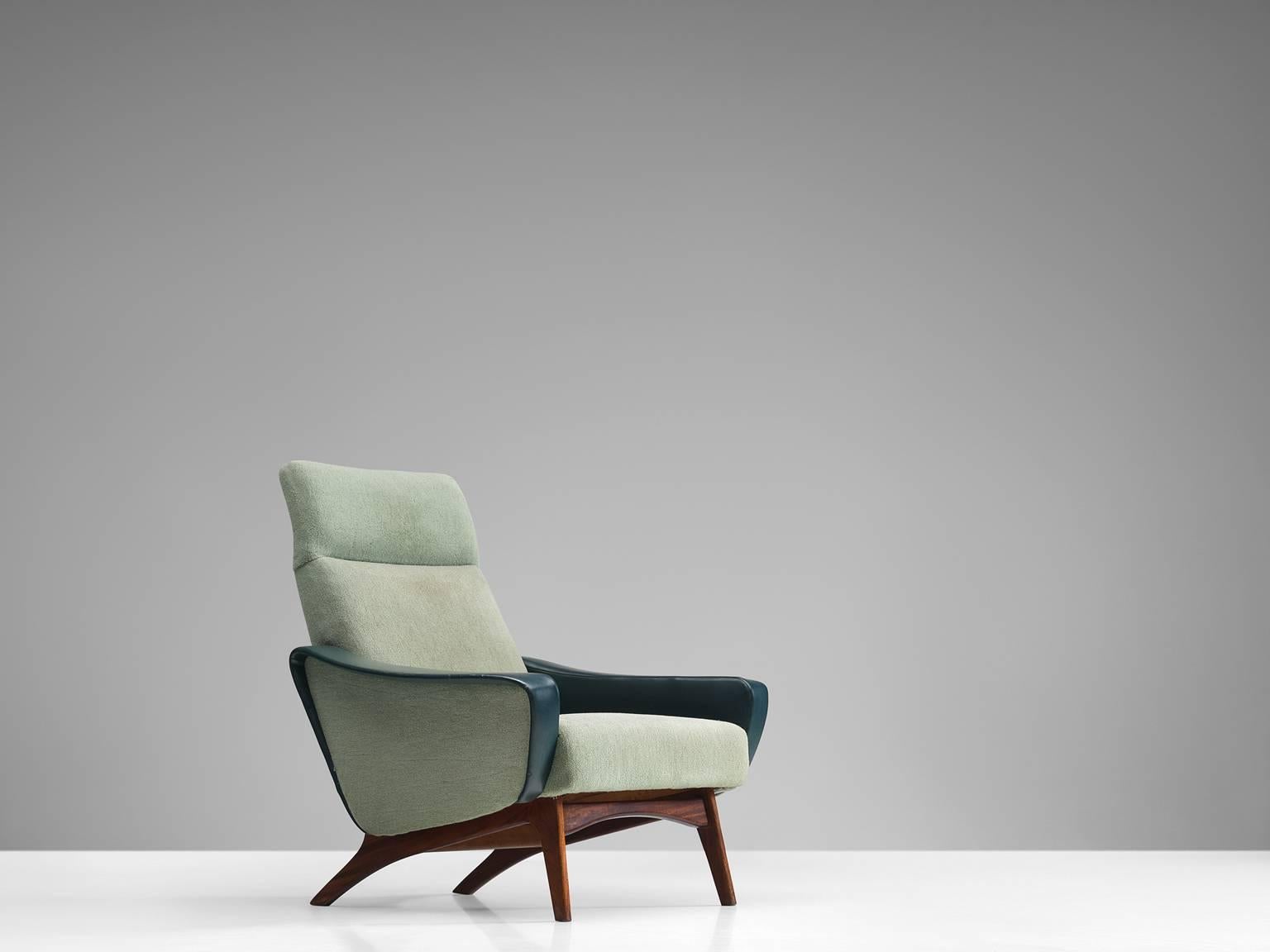Easy chair, fabric, faux leather and wood, Sweden, 1960s.

This armchair features an organic base that is sculptural and crafted in an exquisite manner. The mint green fabric shell shows various layers and rounded shapes. The wide armrests, tilted