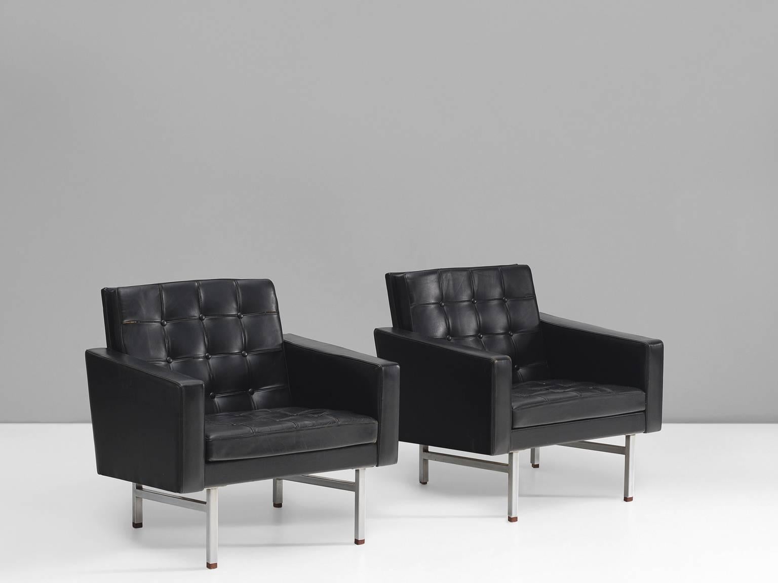 Pair of two lounge chairs, leather, steel and wood by Karl Ekselius, Sweden, 1960s.

This pair of easy chairs is executed in its original black leather. The tufted seat and back in combination with the clean and straight outside and polished steel