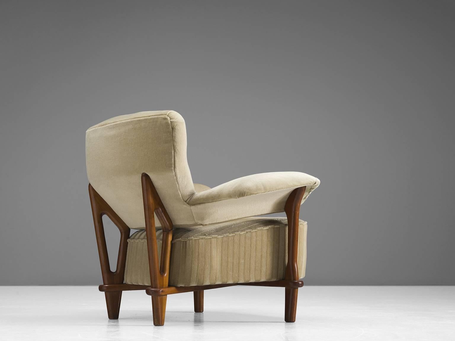 Armchair, velvet and oak, the Netherlands, 1950s.

This velvet, voluptuous armchair by Theo Ruth is a very strong singular item. The back flows with a natural grace into the armrests. The open gap between the backrest and the seating gives the