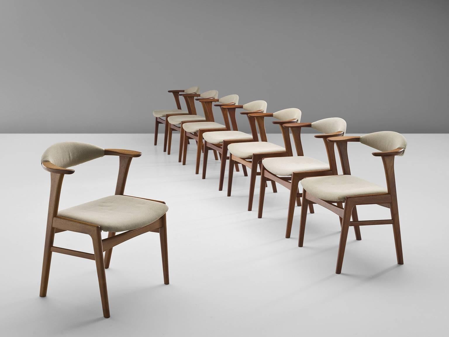 Set of eight armchairs, in teak and fabric by Erik Kirkegaard, Denmark, circa 1952. 

These chairs are executed in solid teak and fabric. The sculptural, small back is one of the main features of this chair. Although the back might look small and