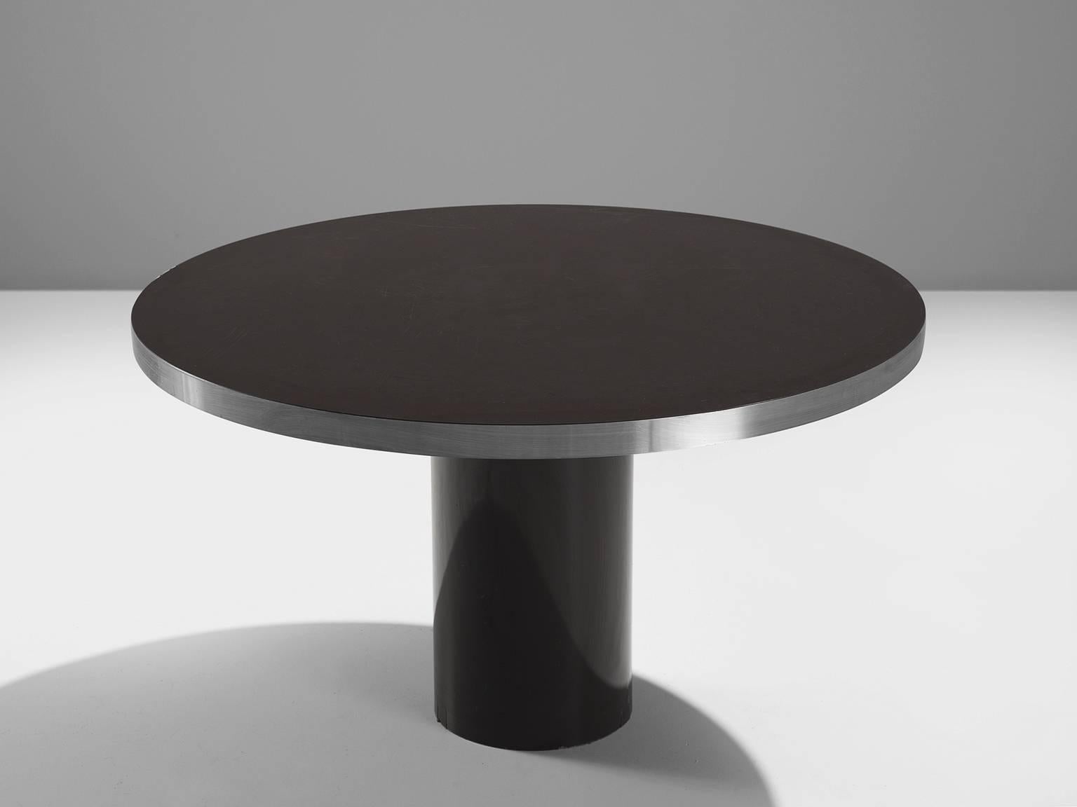 Dining table, high pressured laminate with coating and steel, 1980s, Europe.

This dining is both clean and modest. The design features a single pedestal foot and a circular top finished with mat steel. The table is modest and simplistic. This