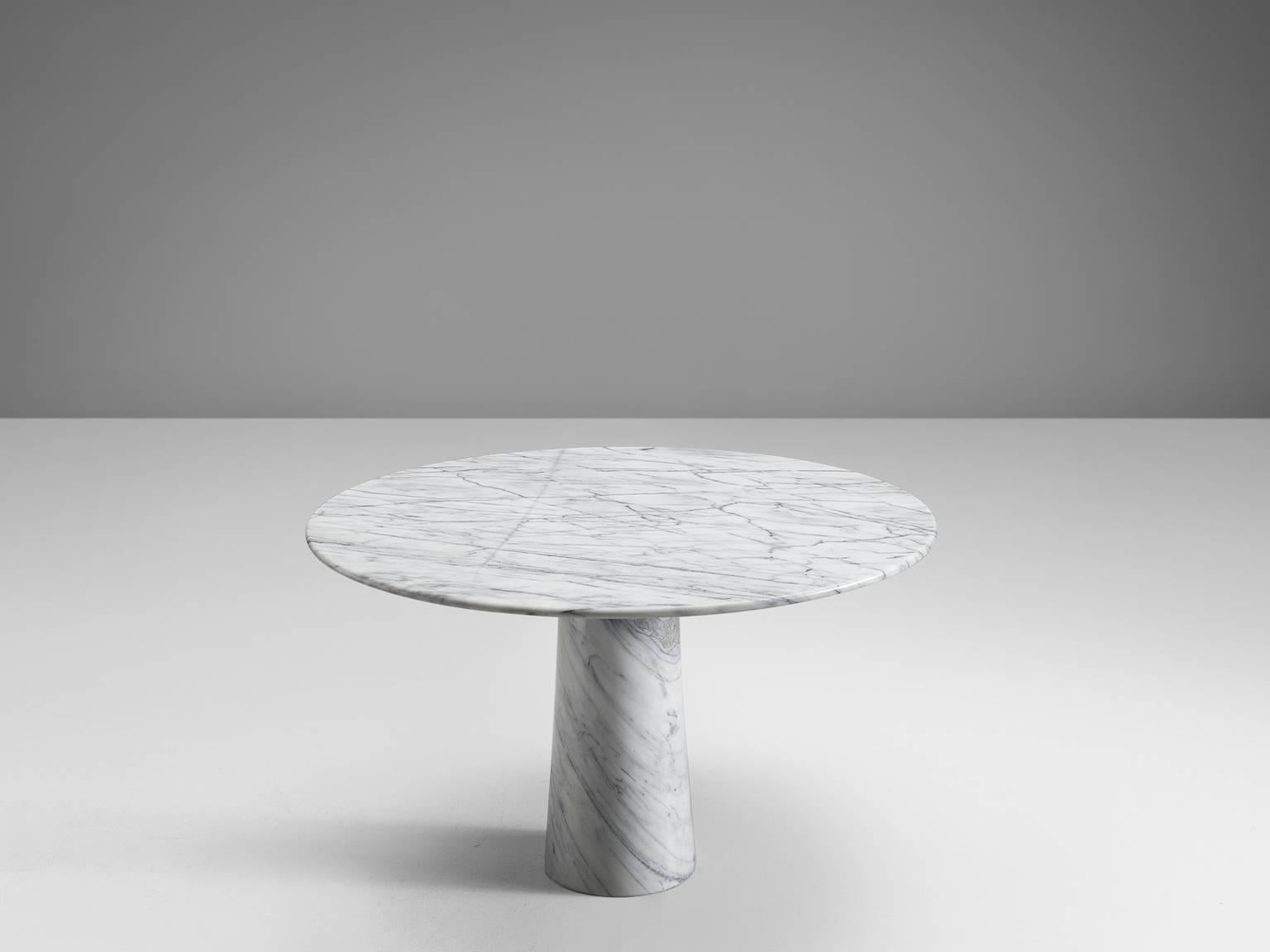 Dining table, marble, Italy, 1970s. 

This architectural table is a skillful example of postmodern design. The circular table features no joints or clamps and is architectural in its structure featuring one single column. The top is formed of a