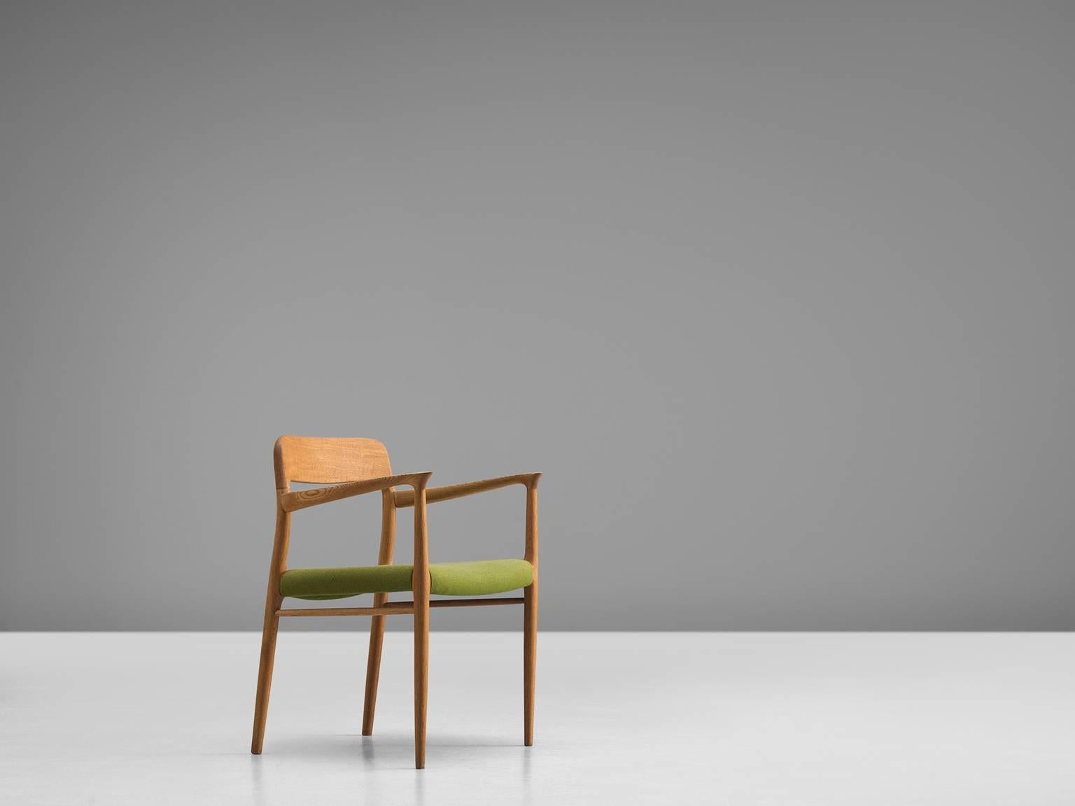 Chair model 56, in oak and green fabric, by Niels Otto Møller for J. L. Møller, Denmark, 1954. 
 
This chair shows subtle lines and beautiful curves of the woodwork.
In the highly refined connections of the wood you can see the work of an expert, a