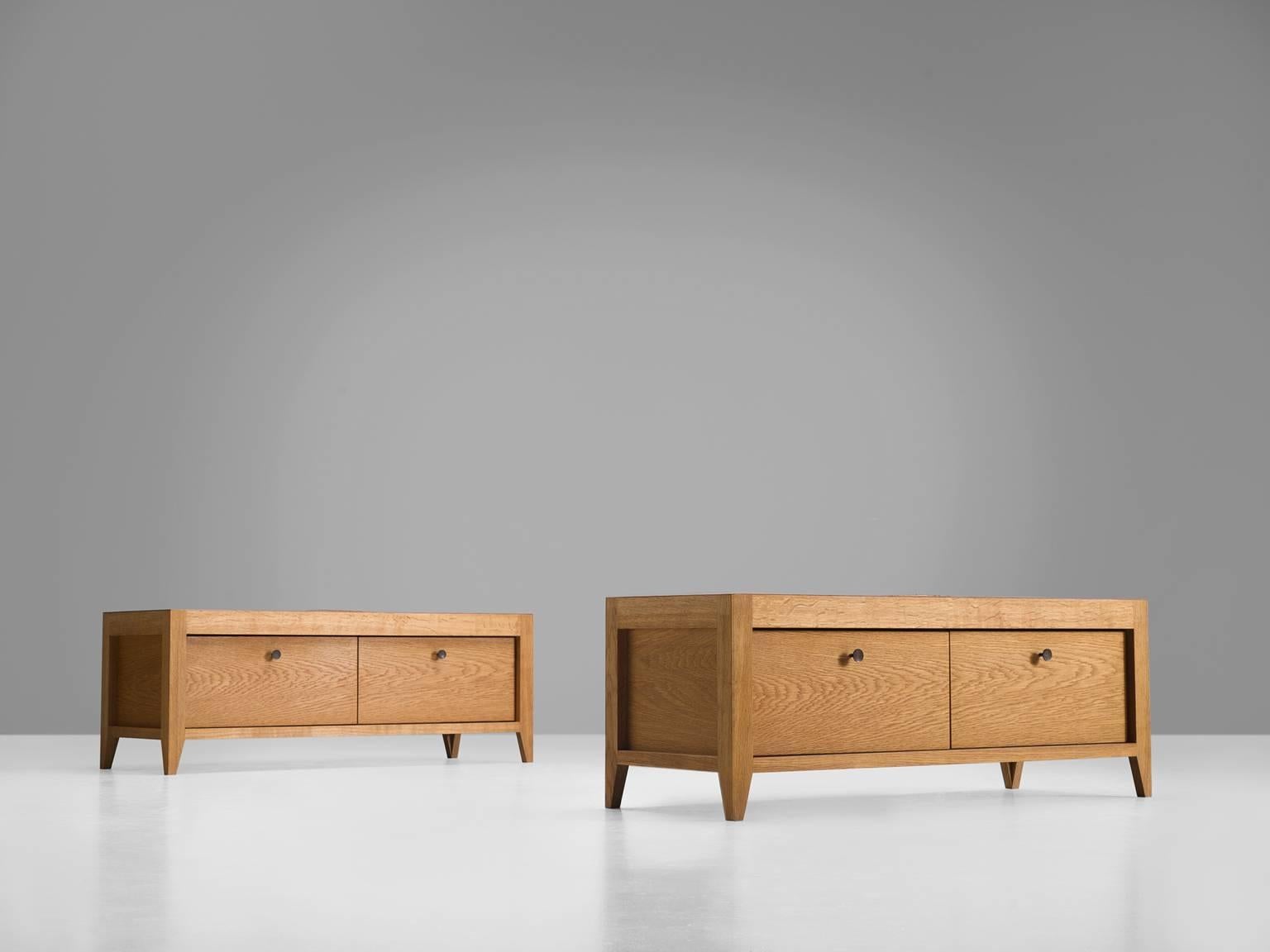 Oak side boards and benches, in leather and oak, Denmark, 1990s.

This low bench versus cabinet features two drawers with browned brass handles and four short, tapered legs. The set is made by the cabinet makers in Denmark and feature the solid