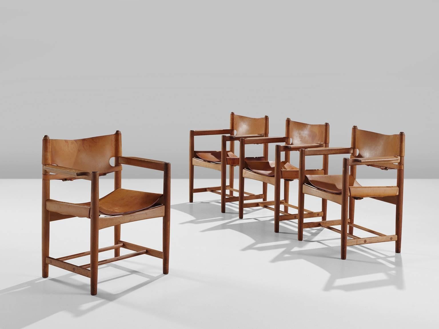 Set of four armchairs model 238, in oak and light beige cognac leather by Børge Mogensen for Fredericia Stolefabrik, Denmark, 1964. 

Set of four armchairs in solid oak. These chairs remind of the classical foldable 'director-chairs', yet this