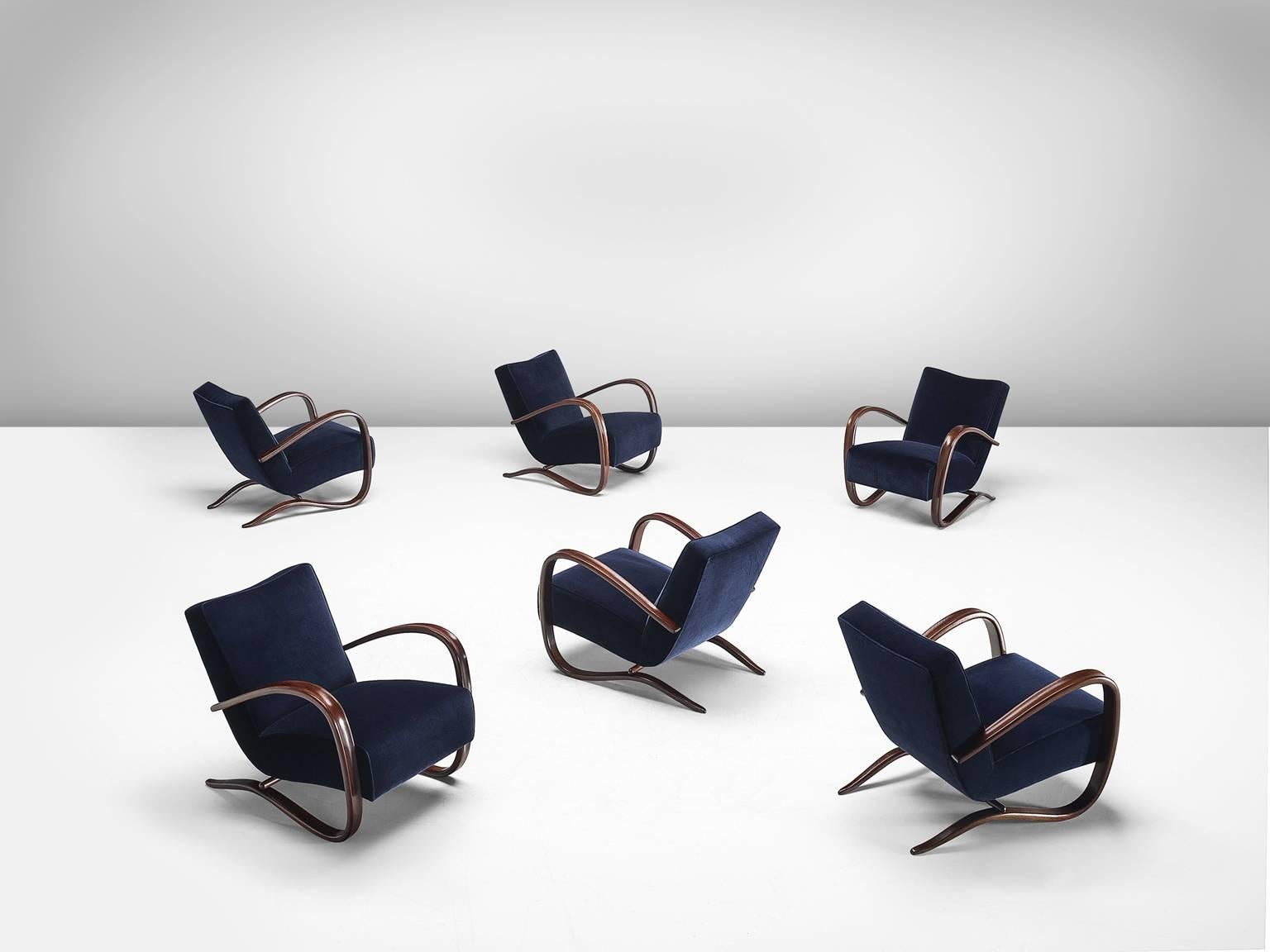 Jindrich Halabala, set of six lounge chairs, in navy blue velvet and beech, by Czech Republic, 1930s. 

Extraordinary pair of easy chairs with dark blue velours upholstery. These chairs have a very dynamic appearance. This dreamy upholstery gives