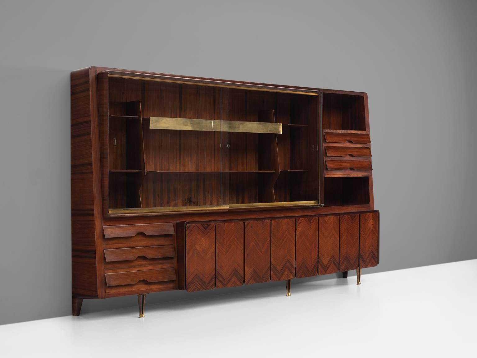 Dassi cabinet, in wood and brass, Italy 1950s.

This Italian chest is highly elegant and refined. The brass panels, handles, and patterned doors are all exquisitely produced. There are closed compartments such as drawers and doors and there are two
