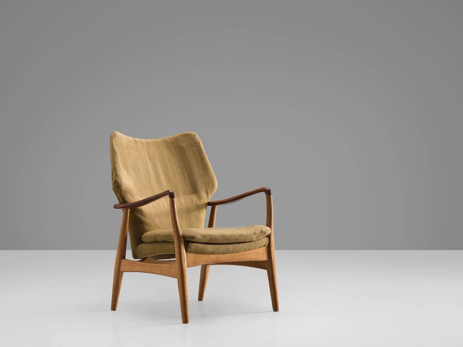 Aksel Bender Madsen for Bovenkamp, oak and teak and yellow to beige fabric, Denmark, 1950s.

This lady lounge chair by Madsen is executed by Bovenkamp. Madsen is known for his modest, Minimalist designs that are often executed in teak or oak. In