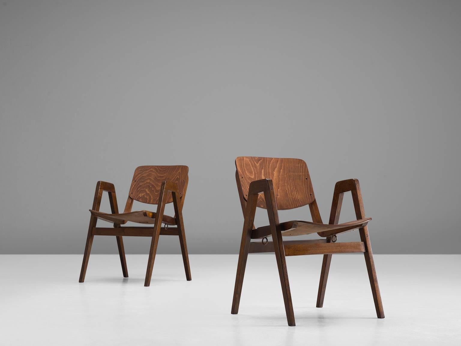 Thonet, set of 12 armchairs, in beech, 1960s.

Set of 12 bended plywood armchairs in a warm patinated beech. These chairs were designed by for the famous bentwood manufacturer Thonet. The most interesting detail in these chairs is the prolongation