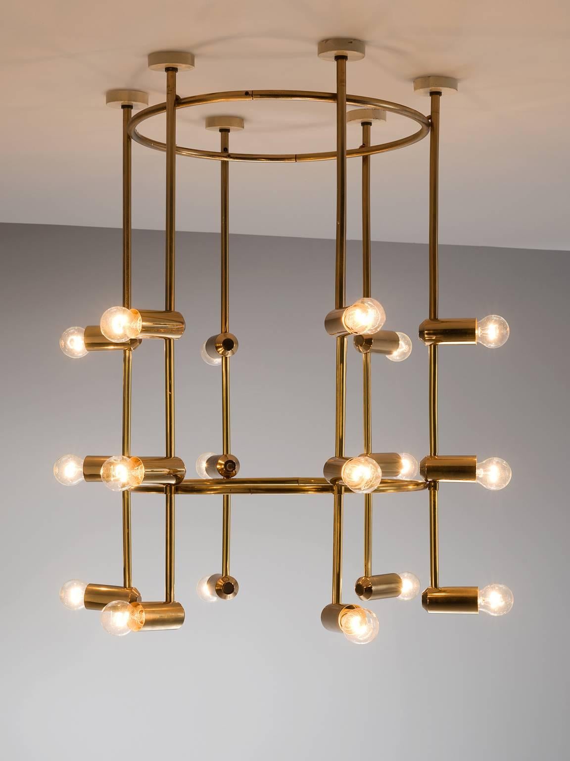 Chandelier, brass, 1960s, Switzerland.

This large yet delicate chandelier is Minimalist yet warm. The light consists of six brass stalks that are attached to a brass ring. There is a lower brass ring on the bottom giving the chandelier both