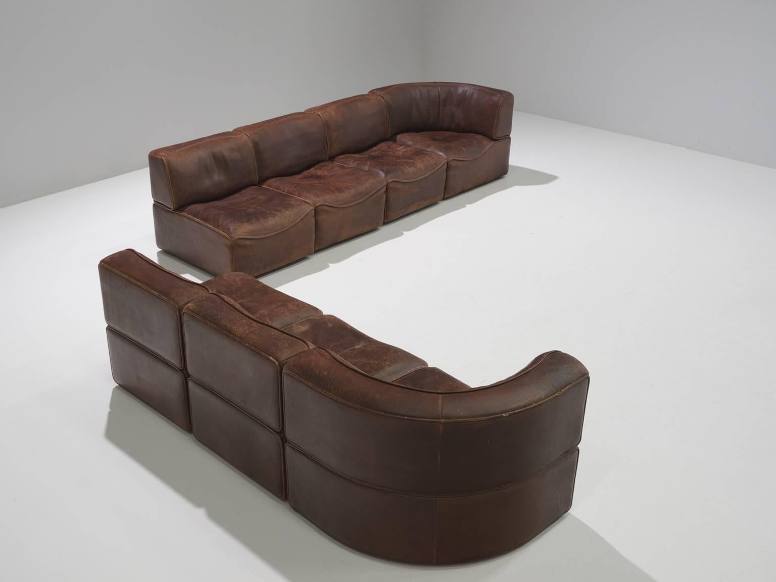 Sectional sofa model DS-15, seven elements, in dark brown leather by De Sede, Switzerland, 1970s. 

This sectional sofa contains two corner elements and five normal elements. The section make it possible to arrange this sofa to your own wishes. The