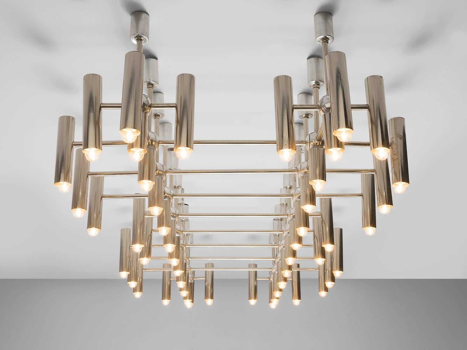 Chandelier, polished steel with 48 bulbs, Europe, 1970s.

This chandelier is executed in chromed steel and features a grid like frame. The grid consists of multiple crosses that are connected with one another. At the end of each cross a tube like