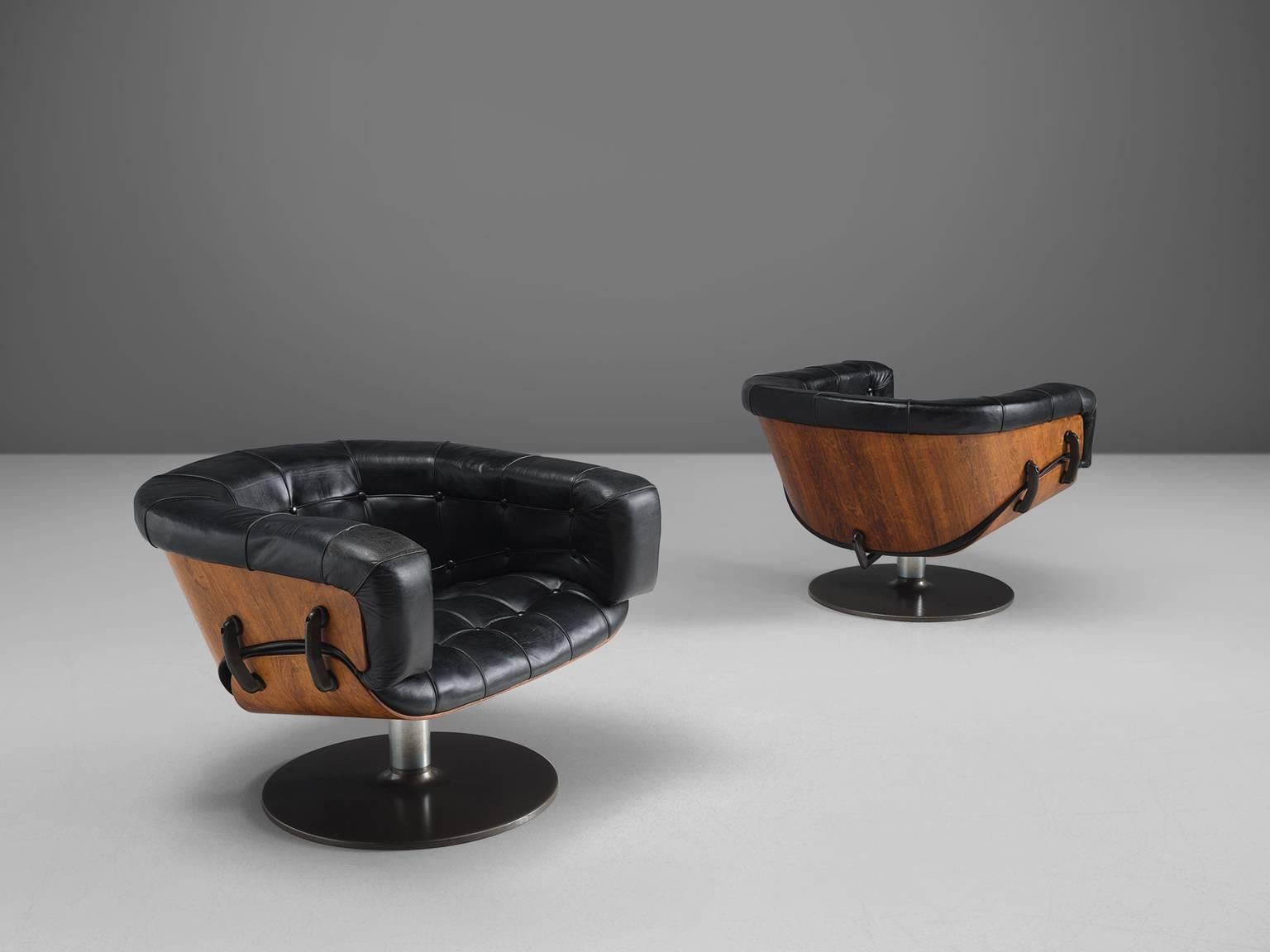 Martin Grierson for Arflex, armchairs, rosewood, leather, metal, 1960, Italy.

The design of this chair is both modernist and contemporary. The shell of this set of club chairs is constructed of two elements of rosewood that is connected via a