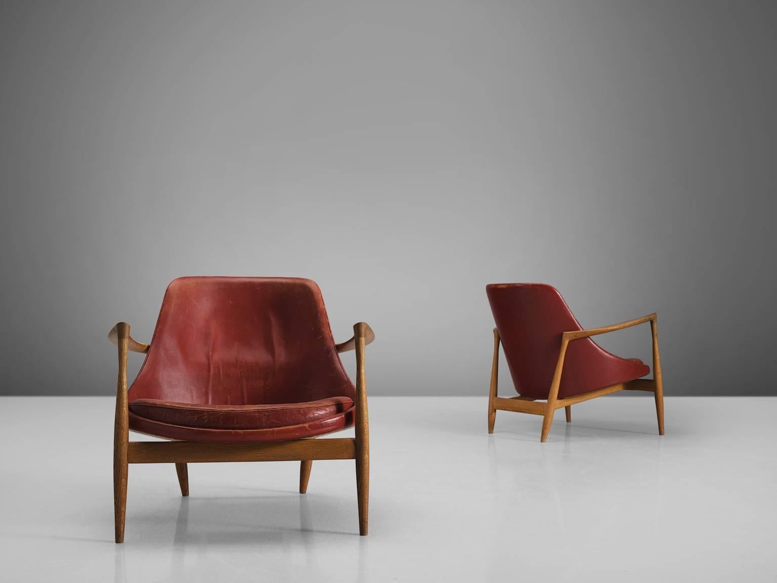 Two lounge chairs, model U-56 'Elizabeth', in oak and leather, by Ib Kofod-Larsen, Denmark, 1956. 

These are two of Kofod-Larsen highest-quality armchairs, with an oak frame and beautiful details in the design. The leather holds beautiful original