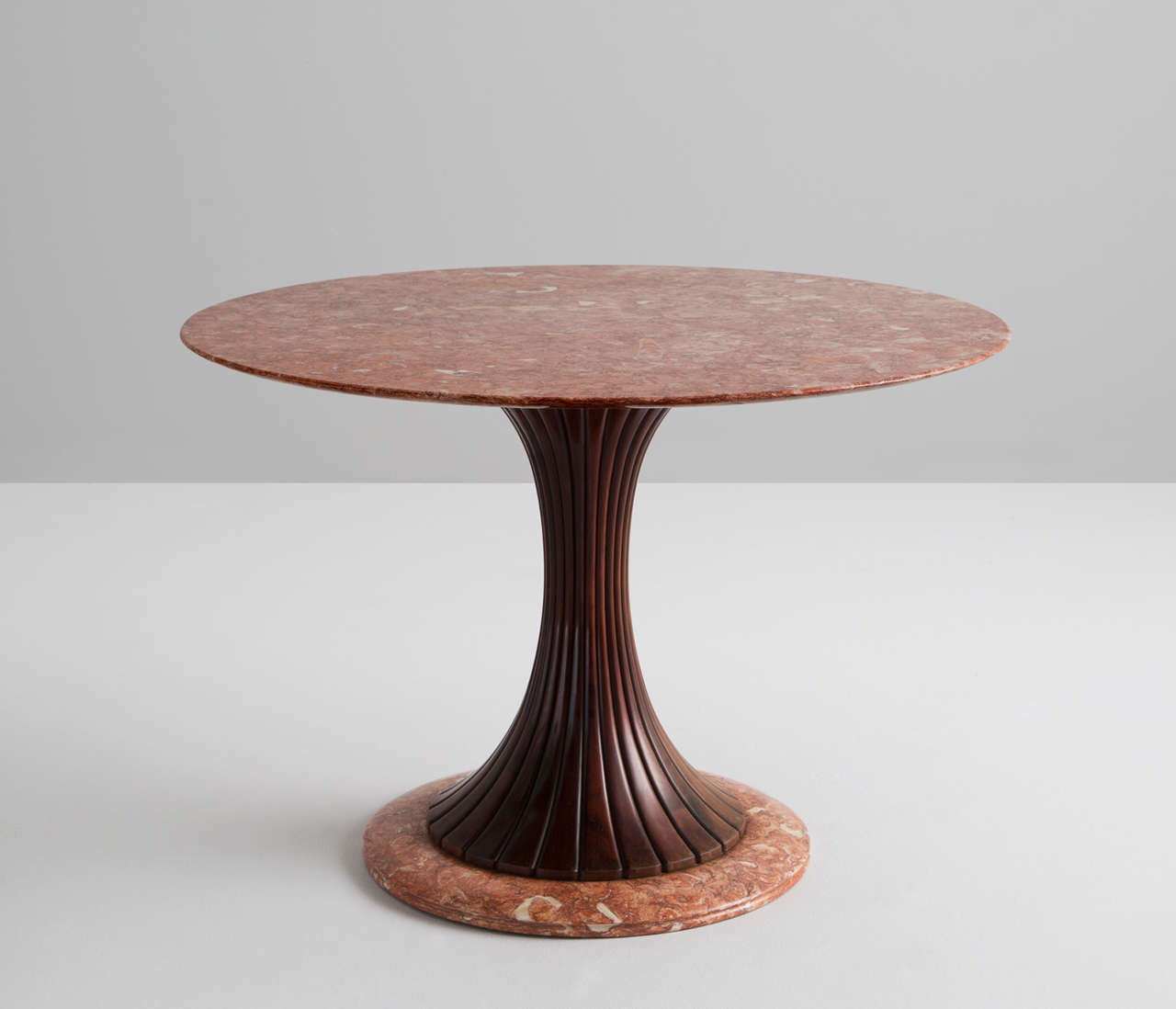 Osvaldo Borsani for Arredamento Borsani, marble wood, Italy, 1950s.

This distinctive centre table is made in the 1950s and holds a wooden decorated shaft. The main feature of this table is the red marble-top. The white and grey veins give a