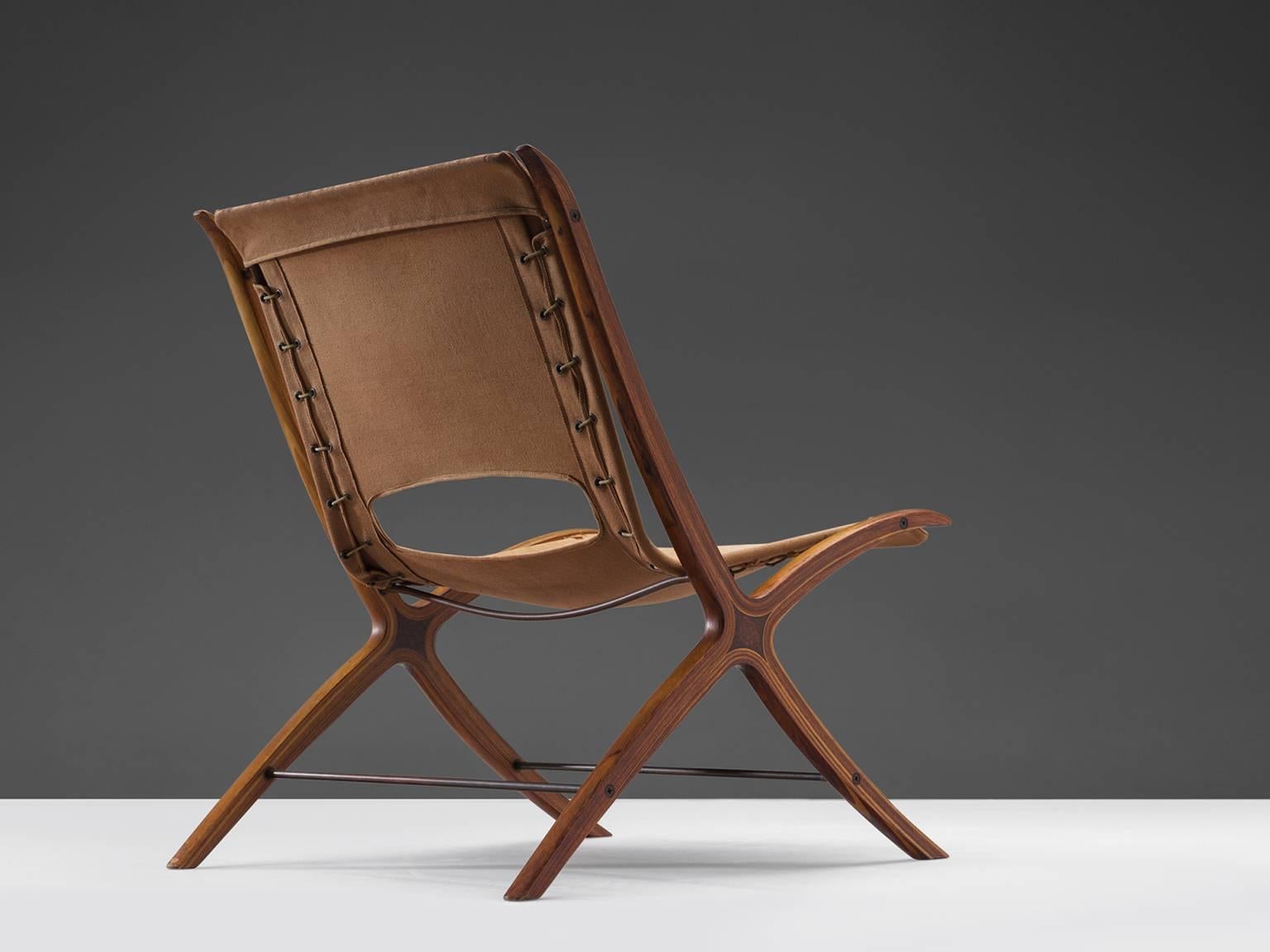 Peter Hvidt & Orla Mølgaard Nielsen for Fritz Hansen, X-chair 'model 6103', original cognac canvas upholstery, laminated, moulded mahogany frame and inlays of bird's-eye wood, 1958.

This chair is for obvious reasons nicknamed the X-chair. The