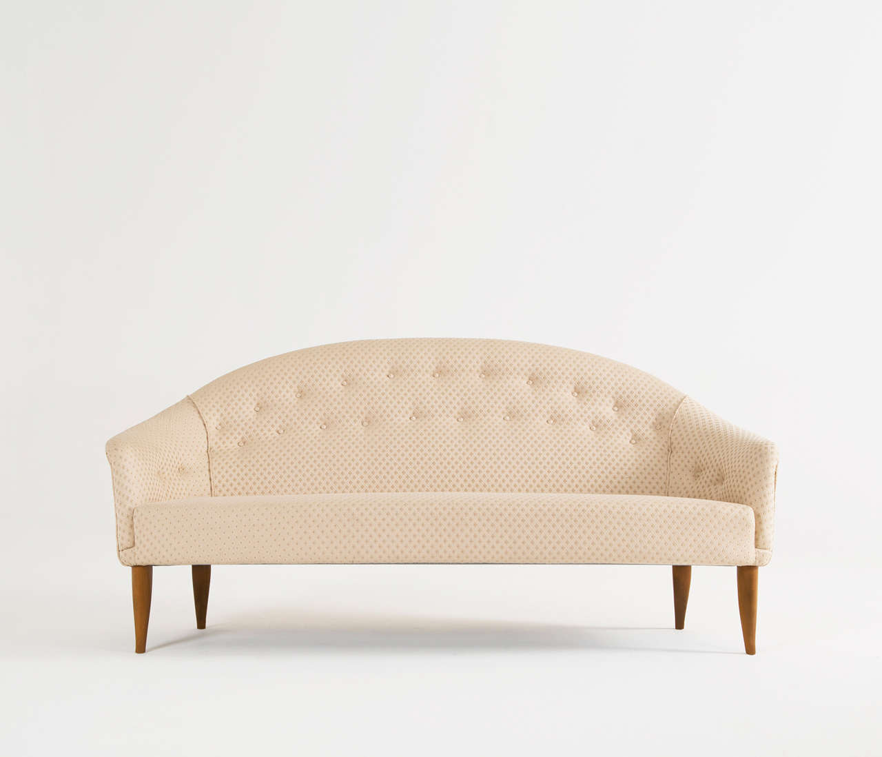Kerstin Horlin Holmqvist for Nordiska Kompaniet, sofa 'Stora paradiset', fabric, wood, Sweden, circa 1958.

The beautifully tapered and curved legs compliment the design of the seat perfectly. The armrests run over smoothly into the back and
