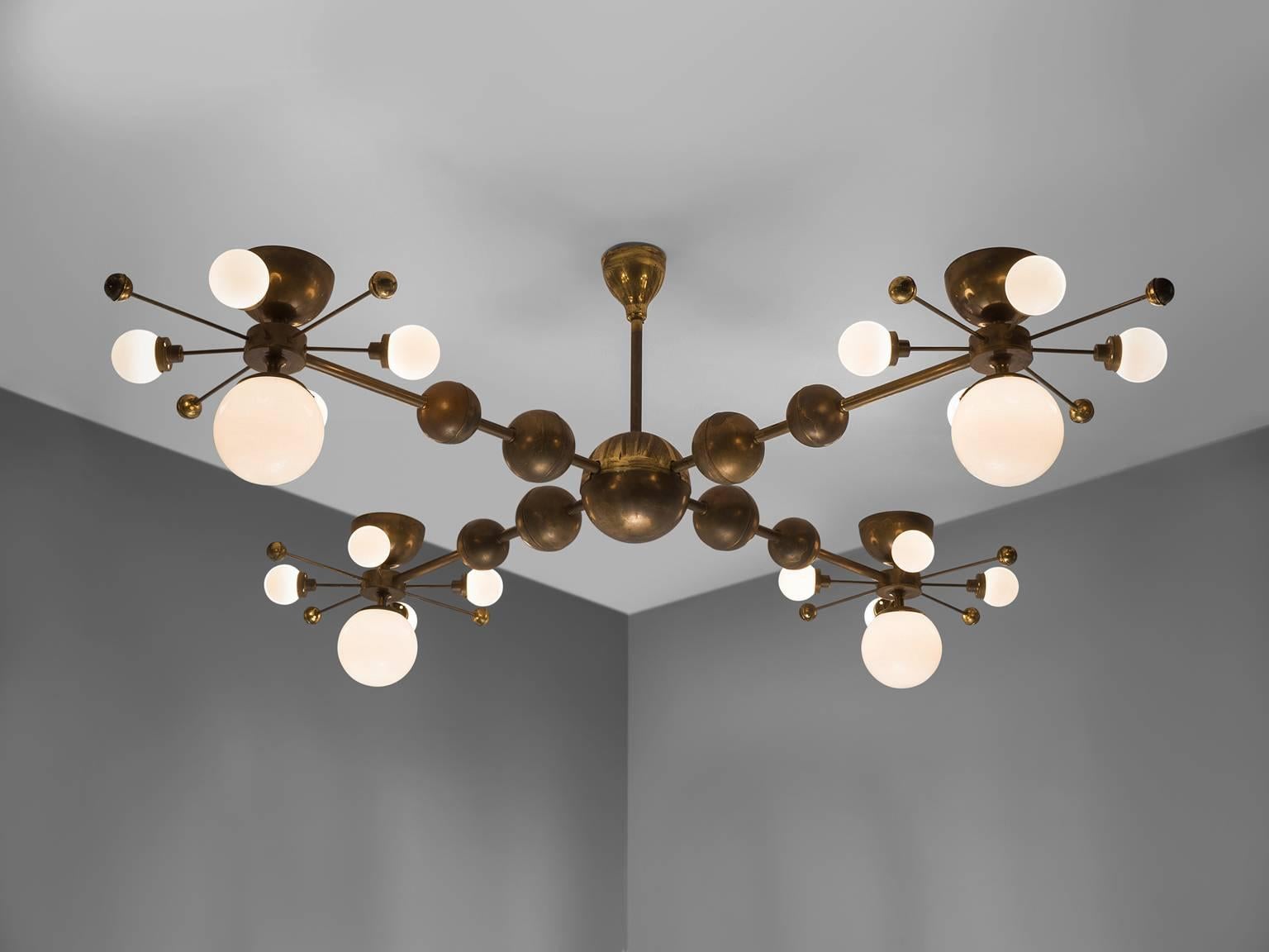 Chandelier, in glass and brass, Europe, 1960s.

Grand chandelier with brass fixture and opaline glass spheres. Due the combination of materials and the several levels, this chandelier has a warm and diffuse light and a stunning light-partition. This