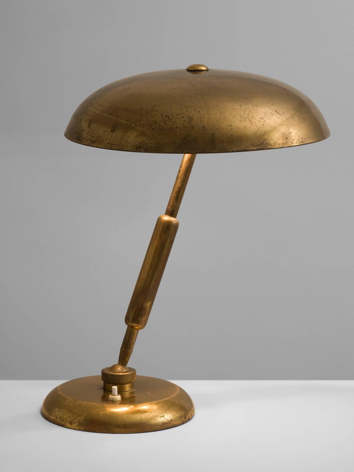 Table light, brass, Italy, 1940s.

This table light is archetypical for a Classic desk light. A round shade is combined with an adjustable brass stalk. This pre war lamp bears traits of the Art Deco and Art Nouveau and is features beautiful warm