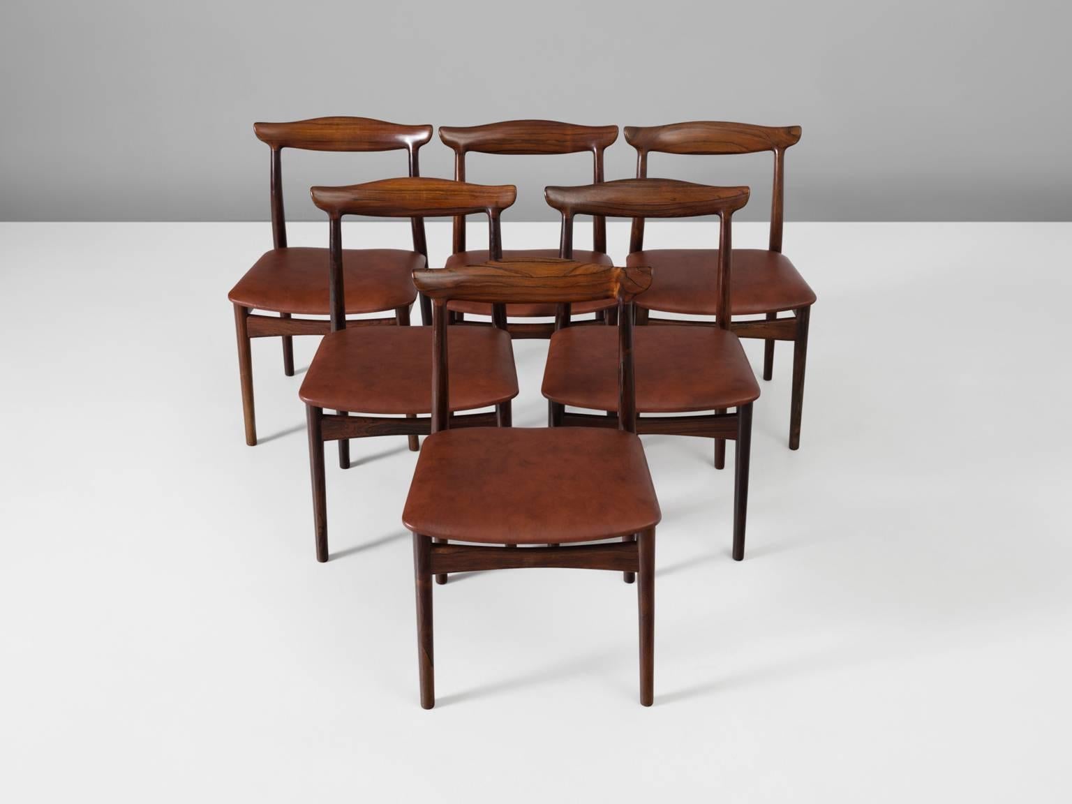 Erik Wortz for Vamo Møbelfabrik, set of six dining chairs model 112, rosewood and leather, Denmark, 1950s. 

Set of six dining room chairs in rosewood and recently reupholstered in brown leather. The four cylindrical legs are tapered and run over