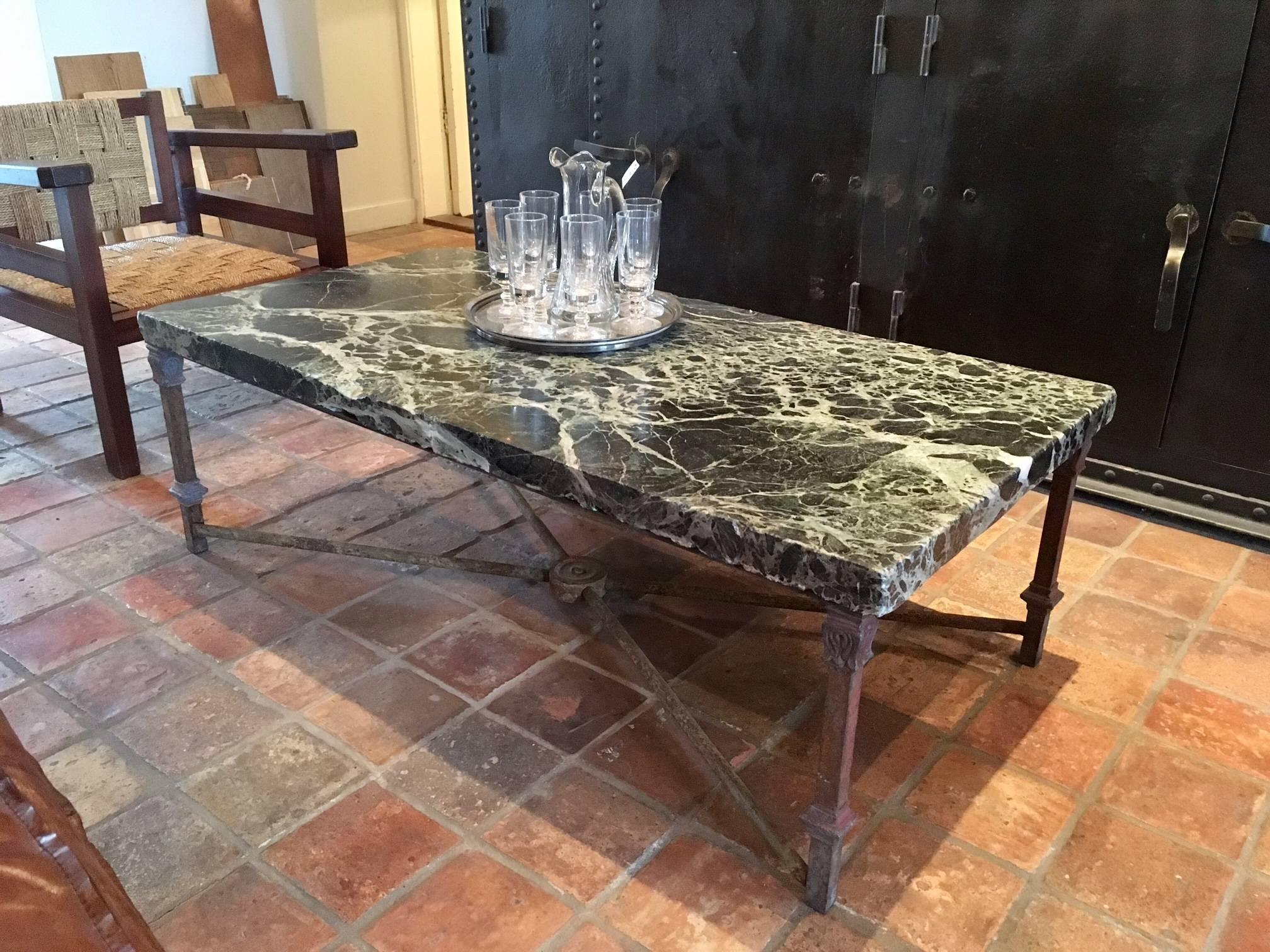This coffee table is compiled from an extraordinary Verde Antico marble top from the 18th century. The iron feet are made from 19th century elements.
 