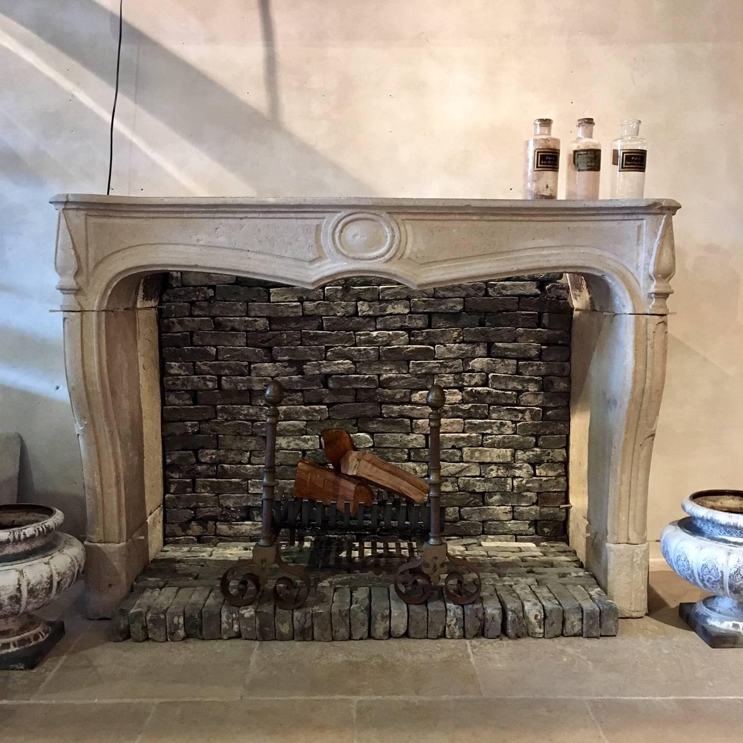 Beautiful fireplace made in France during Louis XIV reign. 

The fireplace is made out of Burgundian limestone, which is a very strong kind of limestone. 

The fireplace has a lovely design with a medaillon in the middle and decorative curves.