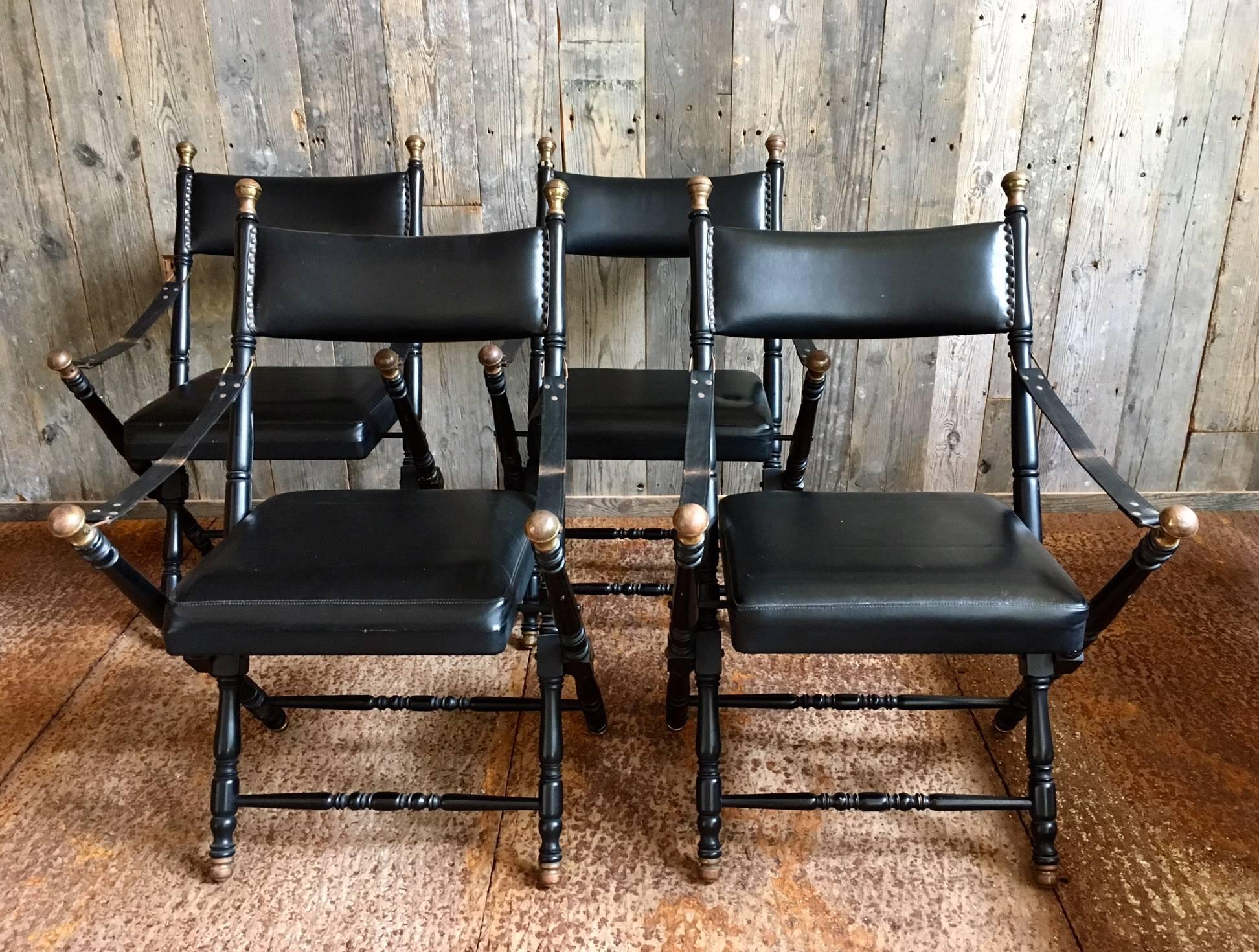 Two black leather Campaign chairs in the style of Maison Jansen.
The leather shows some signs of wear, as does the black paint. This however compliments the vintage feel.

Please note the picture shows 4 chairs, but we have only 2 left. 