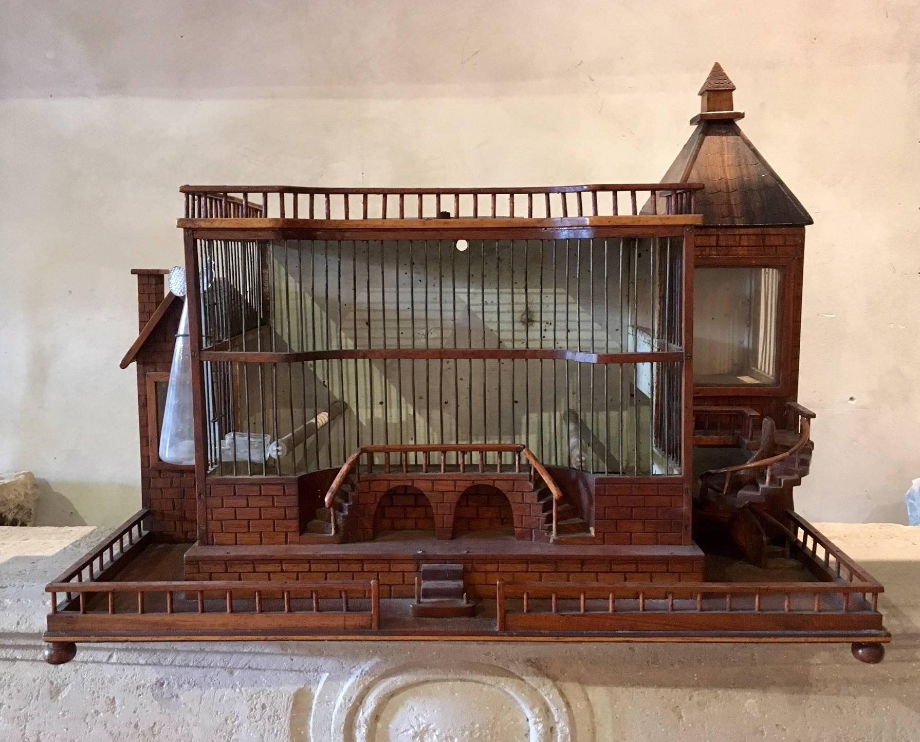 Beautiful wooden bird cage in the shape of a monumental palace. 

On the side is an original glass food tube attached.

This item can still be used as a bird cage, but is also beautiful just to decorate a room. 

Measures: Width 58.5 cm,