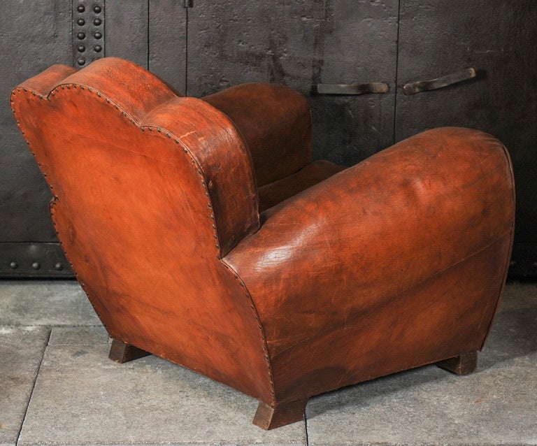 A pair of French Art Deco cognac color leather club chairs, circa 1930.