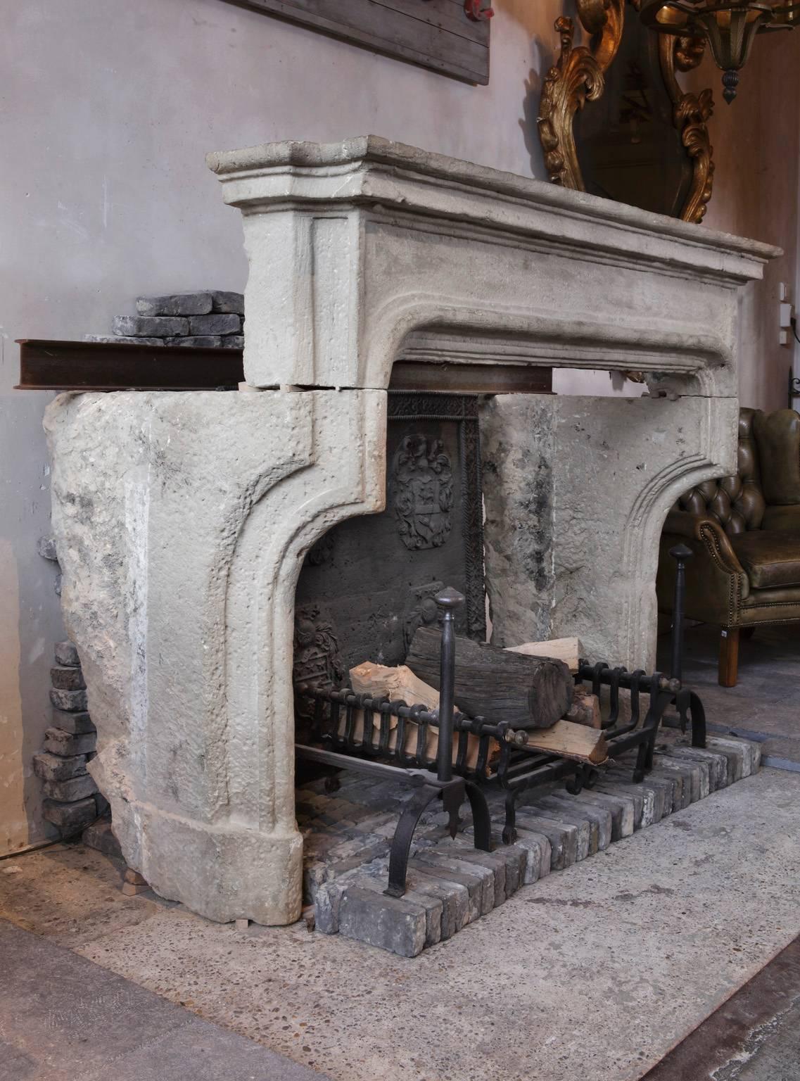 An exceptional late 16th / early 17th century French limestone fireplace or mantel with both Gothic and Louis XIII stylistic elements, respectively the pointedly arched legs and the roundedly profiled front.

Dimensions: 143 cm. high x 189 cm.